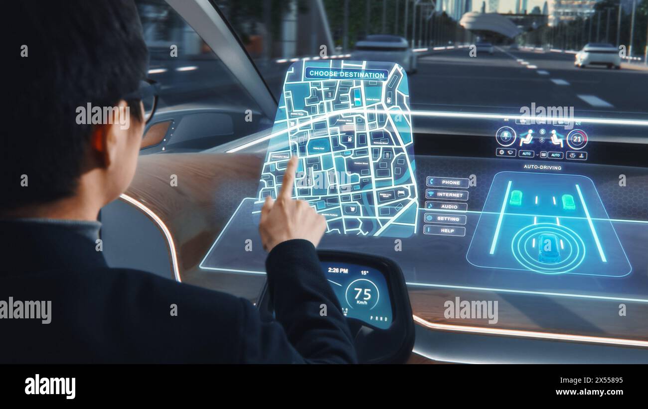 Futuristisches Konzept: Stilvoller Geschäftsmann, der den Standort in einer interaktiven Navigations-App auf einem Augmented Reality Dashboard festlegt, während er in einem autonomen, emissionsfreien Elektroauto sitzt. Stockfoto