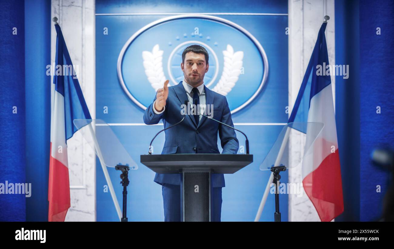 Junge Vertreterin der Organisation bei Pressekonferenz im Regierungsgebäude. Pressesprecher hält eine Rede auf dem Gipfel. Minister im Gespräch mit dem Kongress. Hintergrund mit französischen Flaggen. Stockfoto