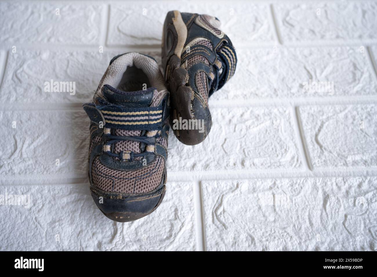 Alte Schuhe für Kinder oder Baby auf dem Boden. Stockfoto