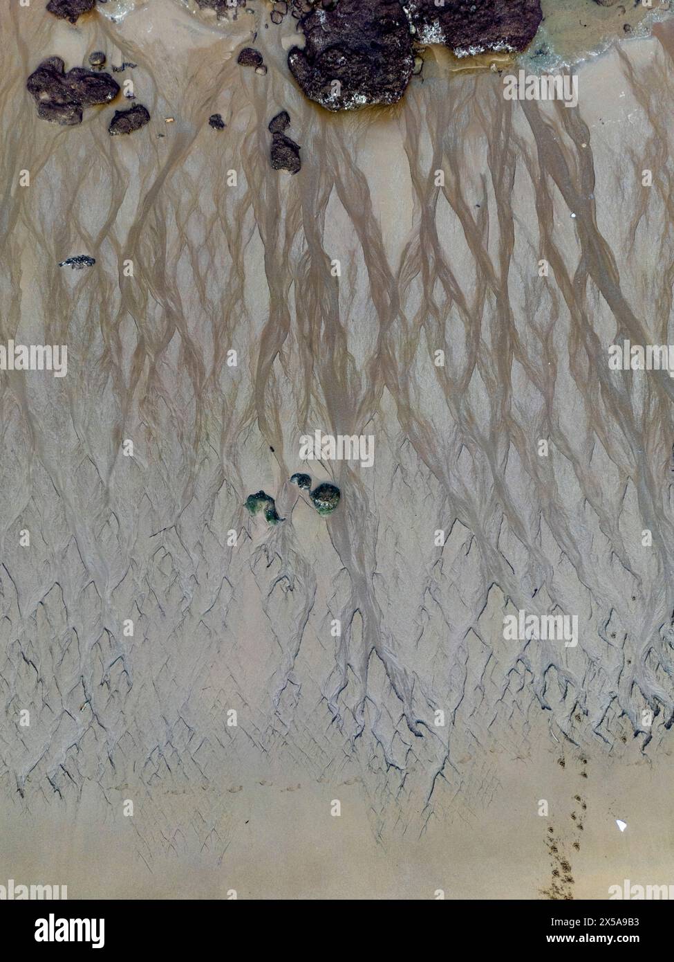 Ein atemberaubender Blick aus der Luft zeigt die einzigartigen Muster, die sich im Sand am Arrigunaga Beach, Getxo, während einer außergewöhnlich niedrigen Flut gebildet haben, mit einem Hauch von Stockfoto