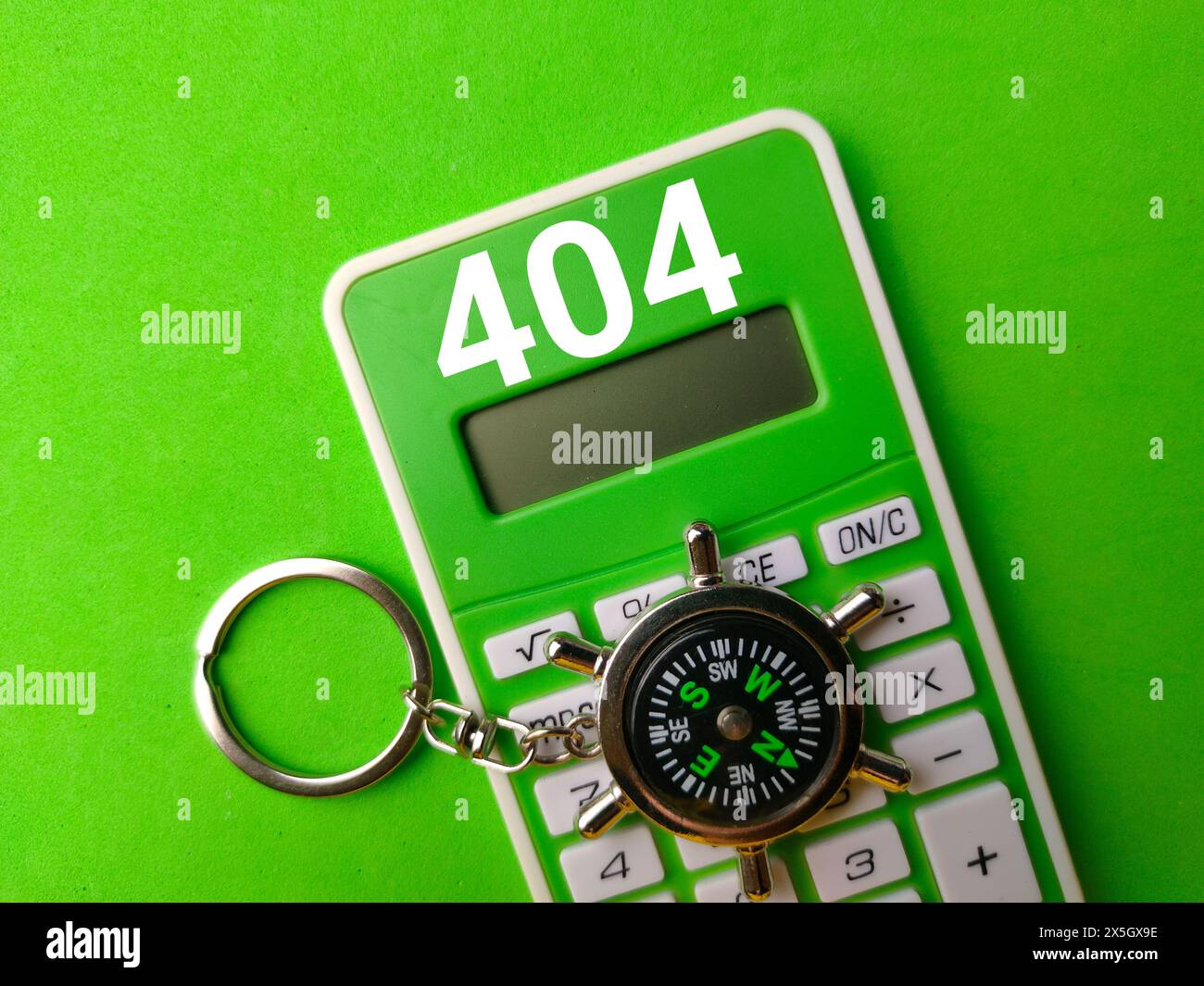 Draufsicht Kompass und Rechner mit der Zahl 404 auf grünem Hintergrund. Stockfoto