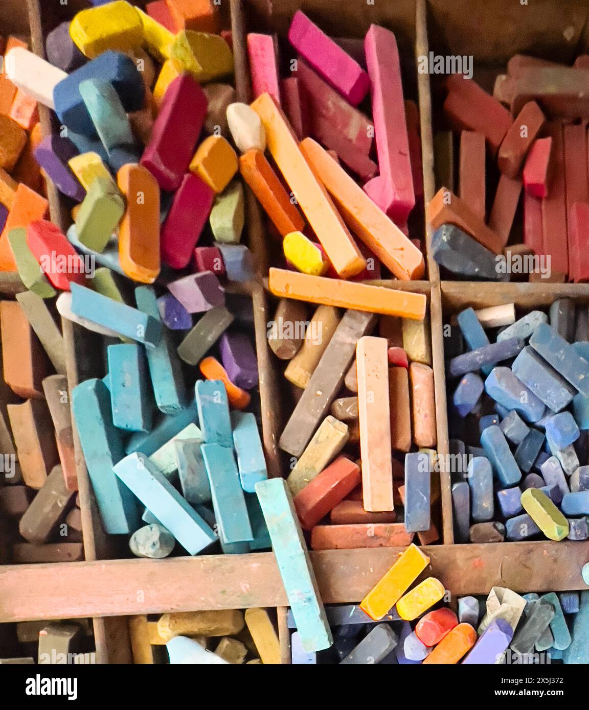 Buntes Pastellsortiment in einer Holzkiste Stockfoto