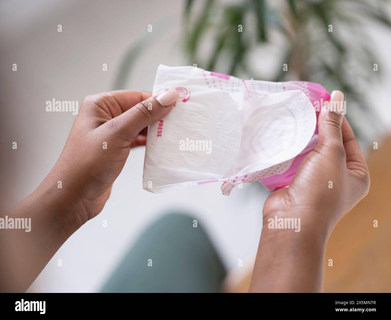 Nahaufnahme der Damenhand, die das Sanitärpolster ausklappt Stockfoto