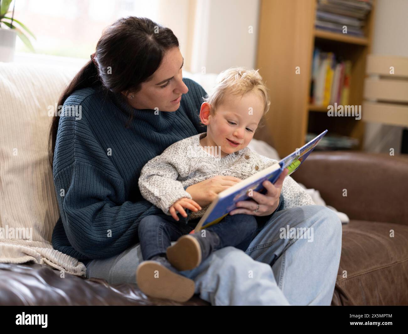 Mutter und Sohn lesen zu Hause Stockfoto