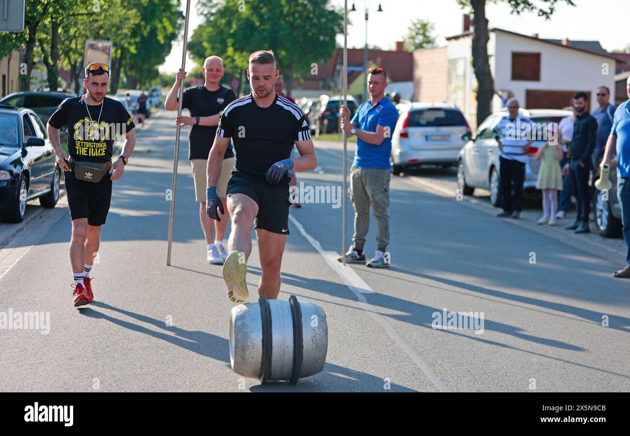 Ballenstedt, Deutschland. Mai 2024. Frank Kranich rollt ein Fass von Hoym nach Badeborn. Die traditionelle Fassrolle von Hoym nach Badeborn wurde wieder in der kleinen Stadt abgehalten. Ein Teilnehmer aus Badeborn muss mit einem Fass eine Distanz von fast 6 Kilometern zurücklegen. Der Fass ist mit Wasser gefüllt und wiegt 60 kg. Frank Kranich entschied sich, dieses Jahr teilzunehmen. Er trainierte acht Wochen lang. Die 39. Walzenrolle stammt von einer Wette aus dem Jahr 1984, als erstmals ein Walzenfass von Hoym nach Badeborn gerollt wurde. Quelle: Matthias Bein/dpa/Alamy Live News Stockfoto