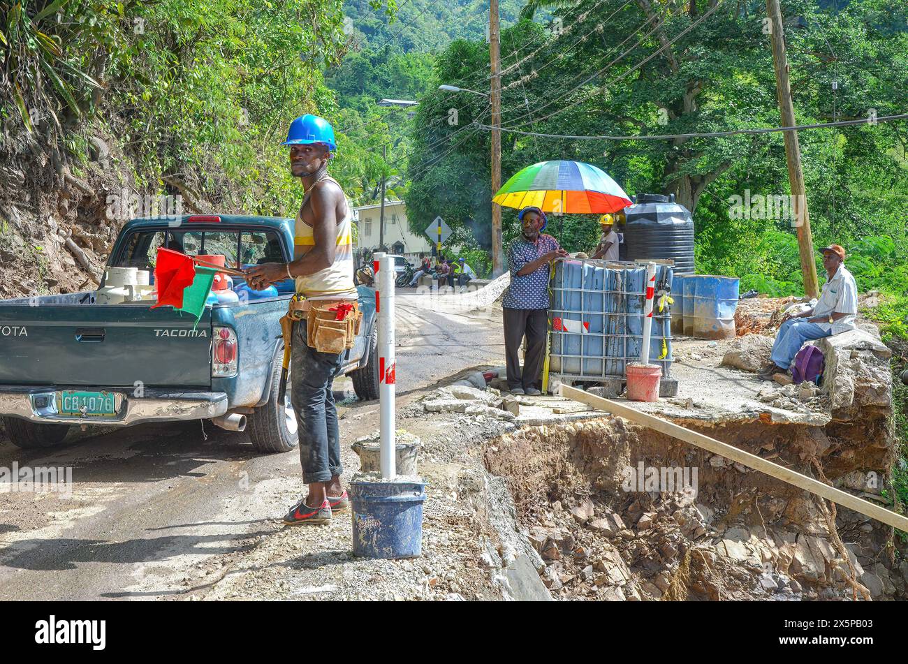 Tage nach einem Hurrikan reparieren Arbeiter Sturmschäden, die auf einer Straße die Blue Mountains hinauf angerichtet wurden. Die Straße mit einem prekären Abstieg zur Seite bricht oft zusammen. Stockfoto