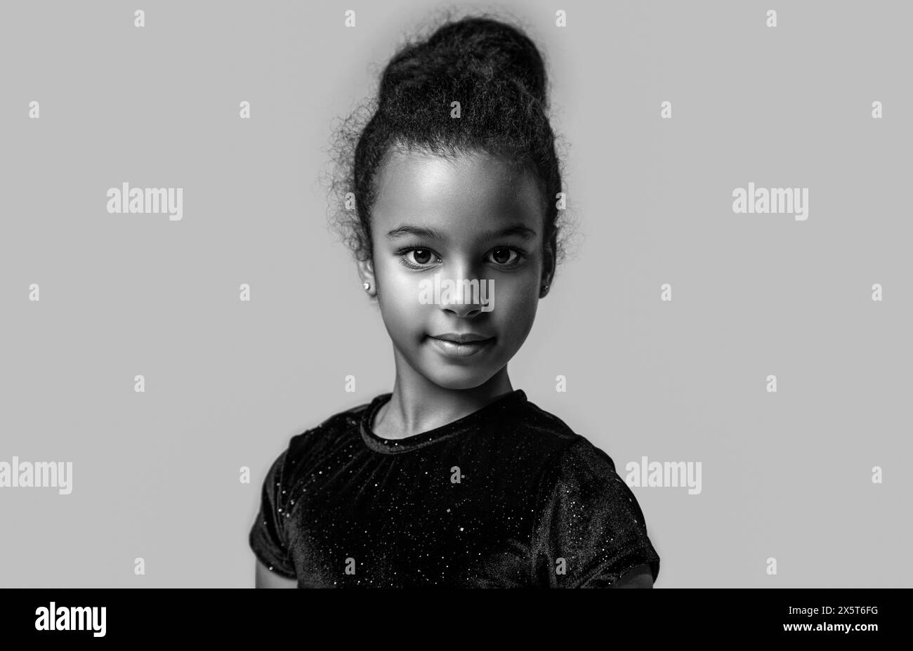 Lächeln Sie das kleine afrikanische Mädchen. Amerikanisches Mädchen Lächeln und lockiges Haar. Schwarz-weiß. Stockfoto