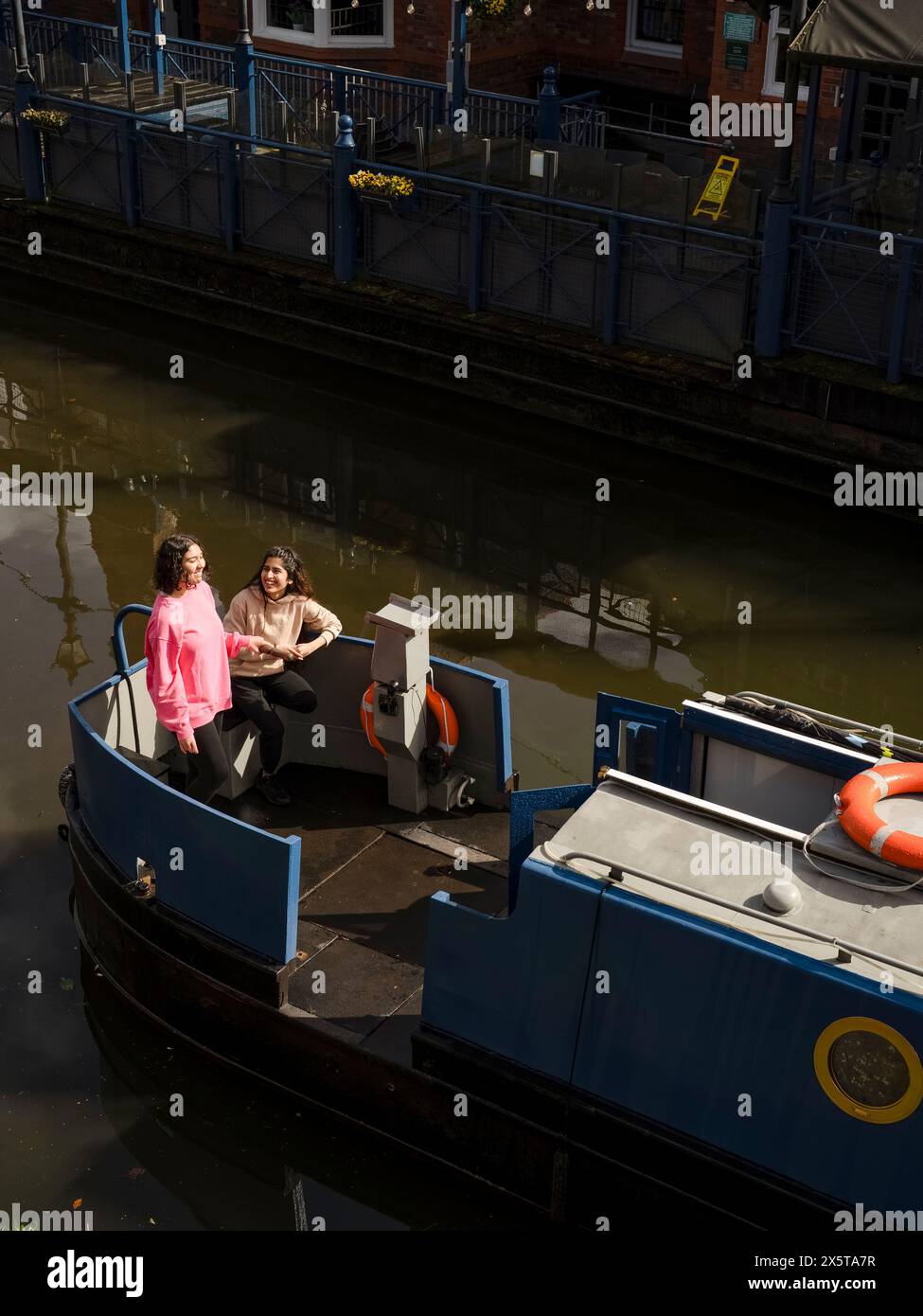 Hochwinkelansicht von Frauen auf dem Boot im Kanal Stockfoto