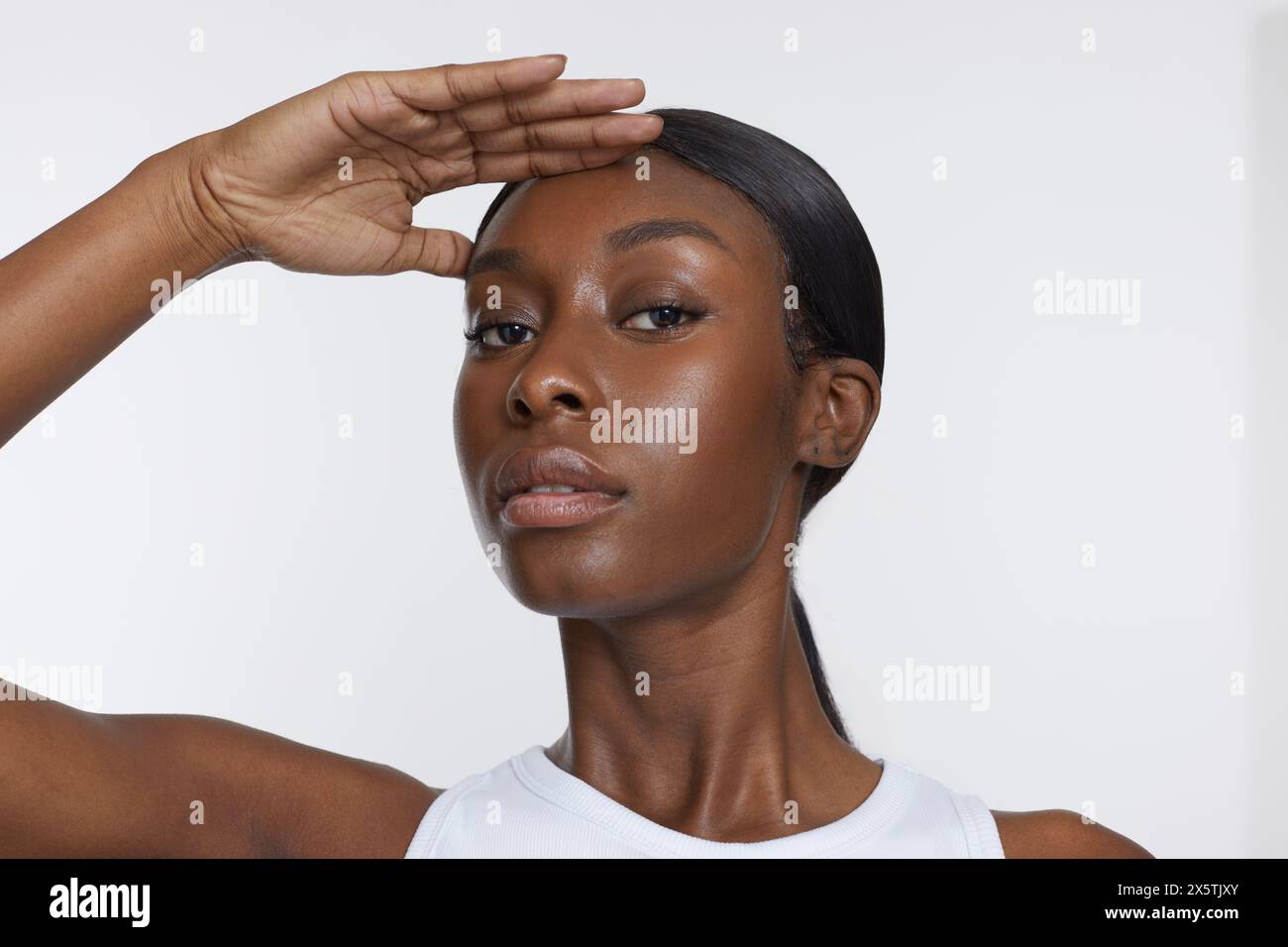 Atelierporträt einer Sportfrau, die Augen abschirmt Stockfoto