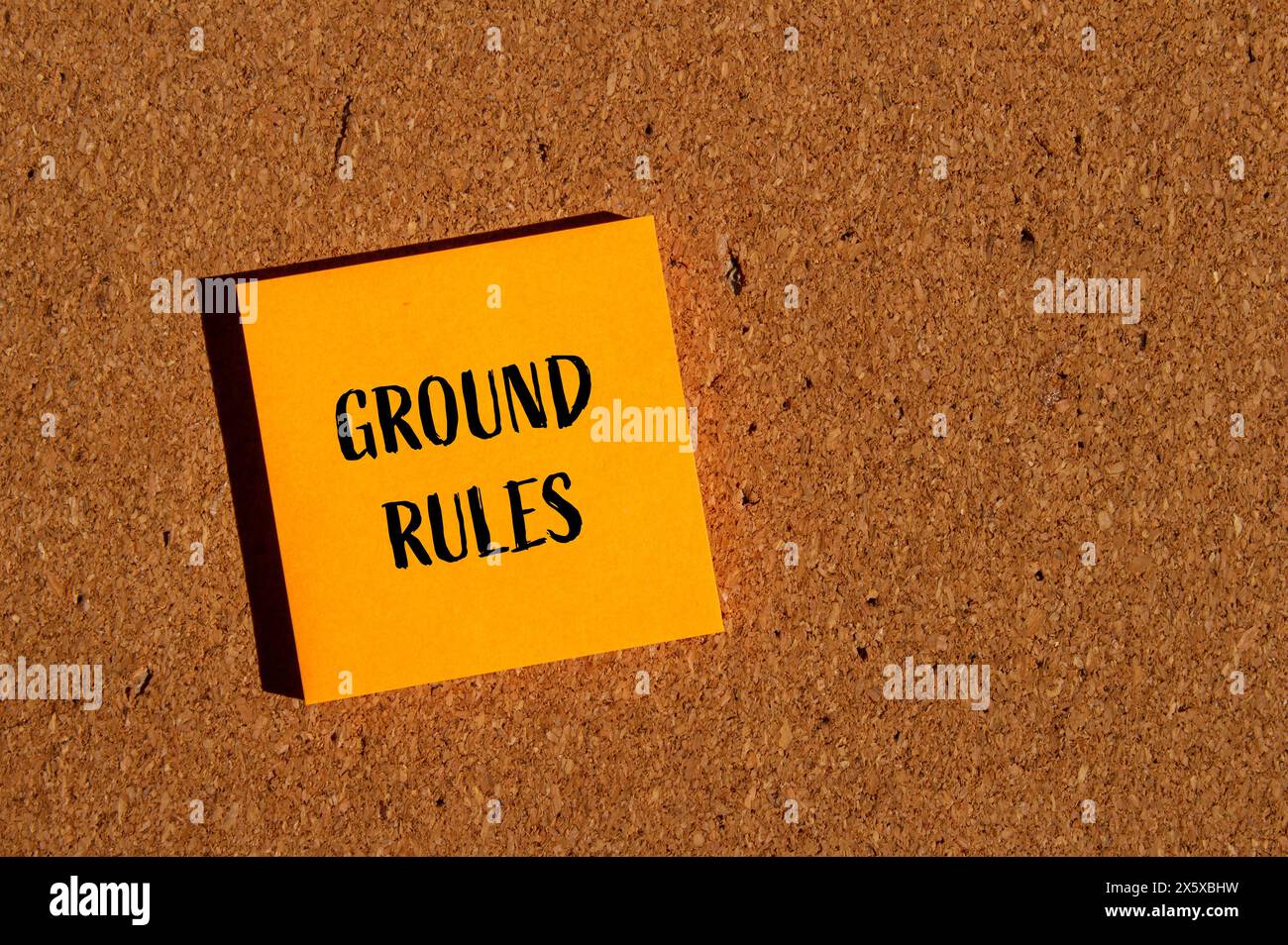 Grundregeln Wörter auf orangefarbenem Papieraufkleber mit braunem Hintergrund. Symbol für konzeptionelle Grundregeln. Kopierbereich. Stockfoto