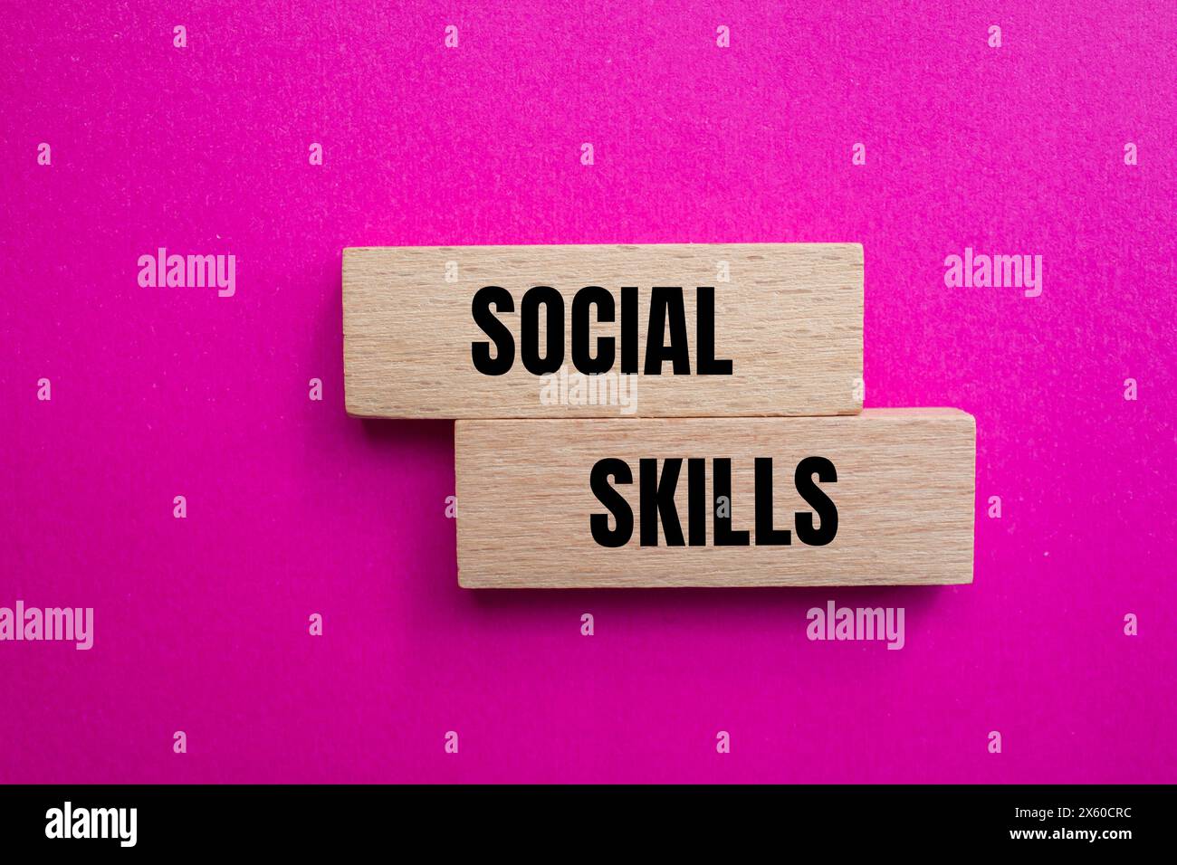 Wörter für soziale Fähigkeiten, geschrieben auf Holzblöcken mit rosa Hintergrund. Symbol für konzeptionelle soziale Fähigkeiten. Kopierbereich. Stockfoto