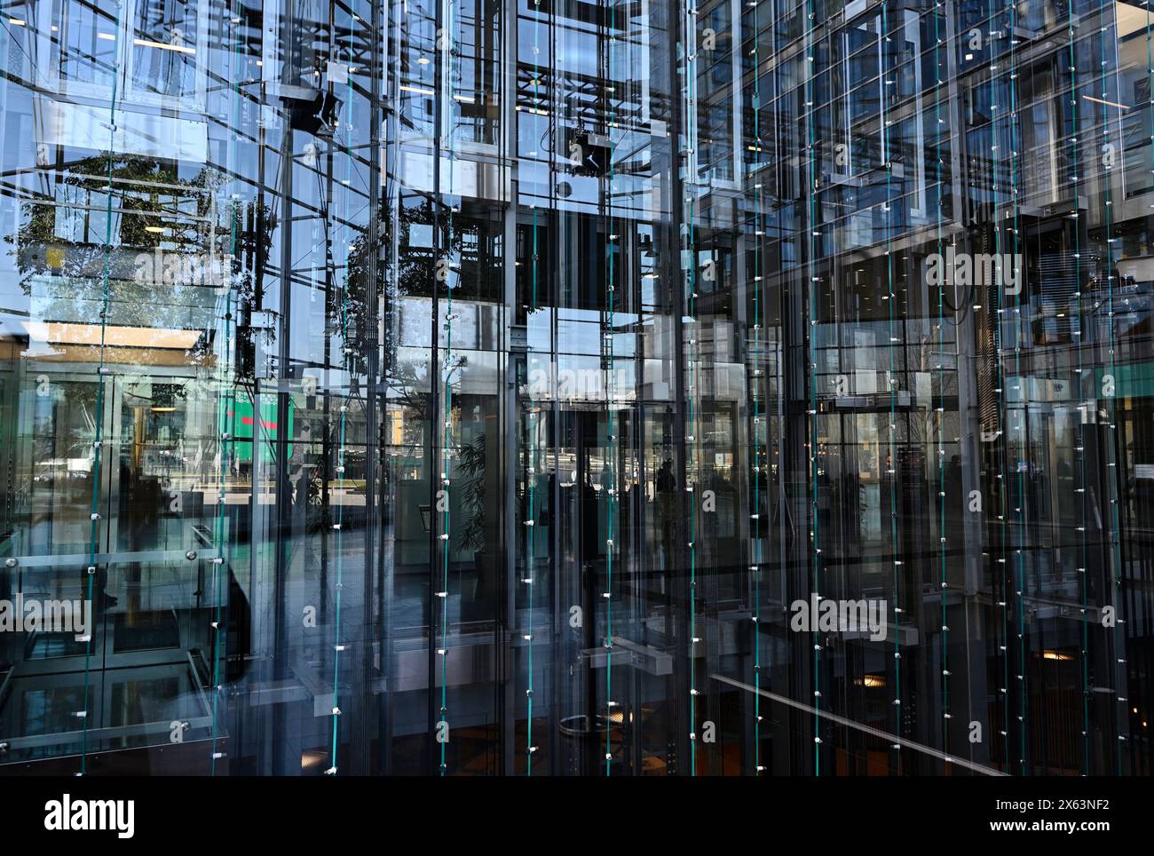 Fahrstühle hinter einer Glaswand in einem modernen Bürogebäude Stockfoto