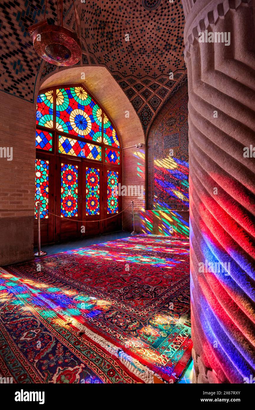 Ein Lichtspiel aus mehrfarbigen Buntglasfenstern in der Nasir al-Mulk Moschee aus dem 19. Jahrhundert, auch bekannt als die Rosa Moschee. Shiraz, Iran. Stockfoto