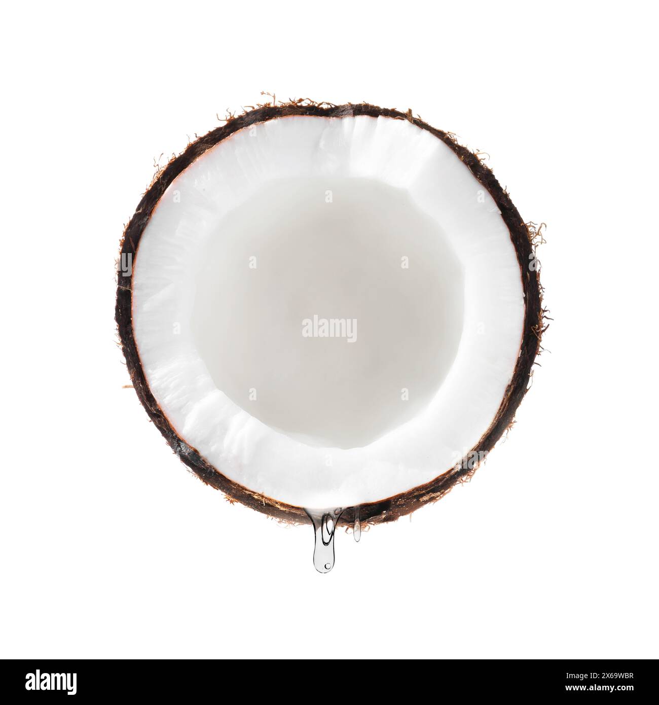 Kokosnuss mit tropfendem Öl isoliert auf weiß Stockfoto