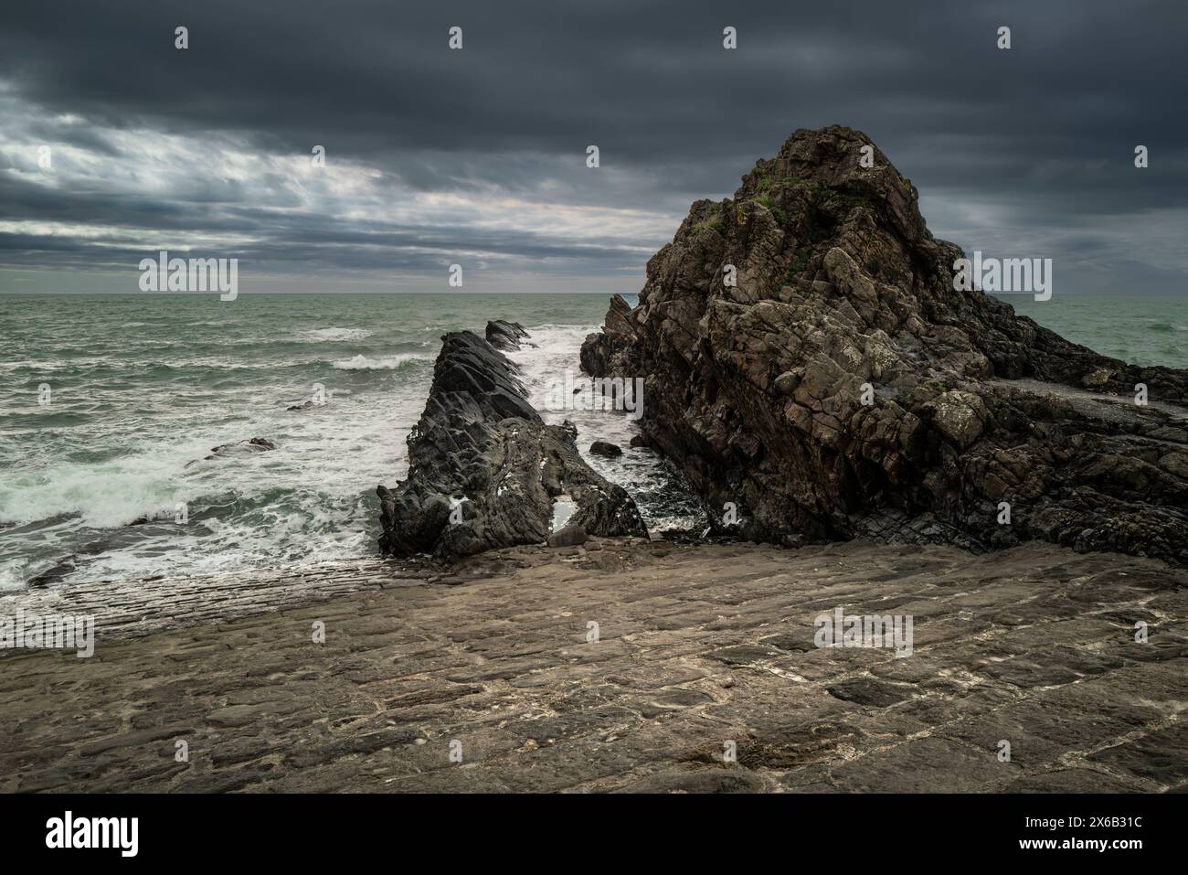 Felsen am Ende des historischen Mole Deichs an der Küste von Bude in Cornwall in Großbritannien Stockfoto