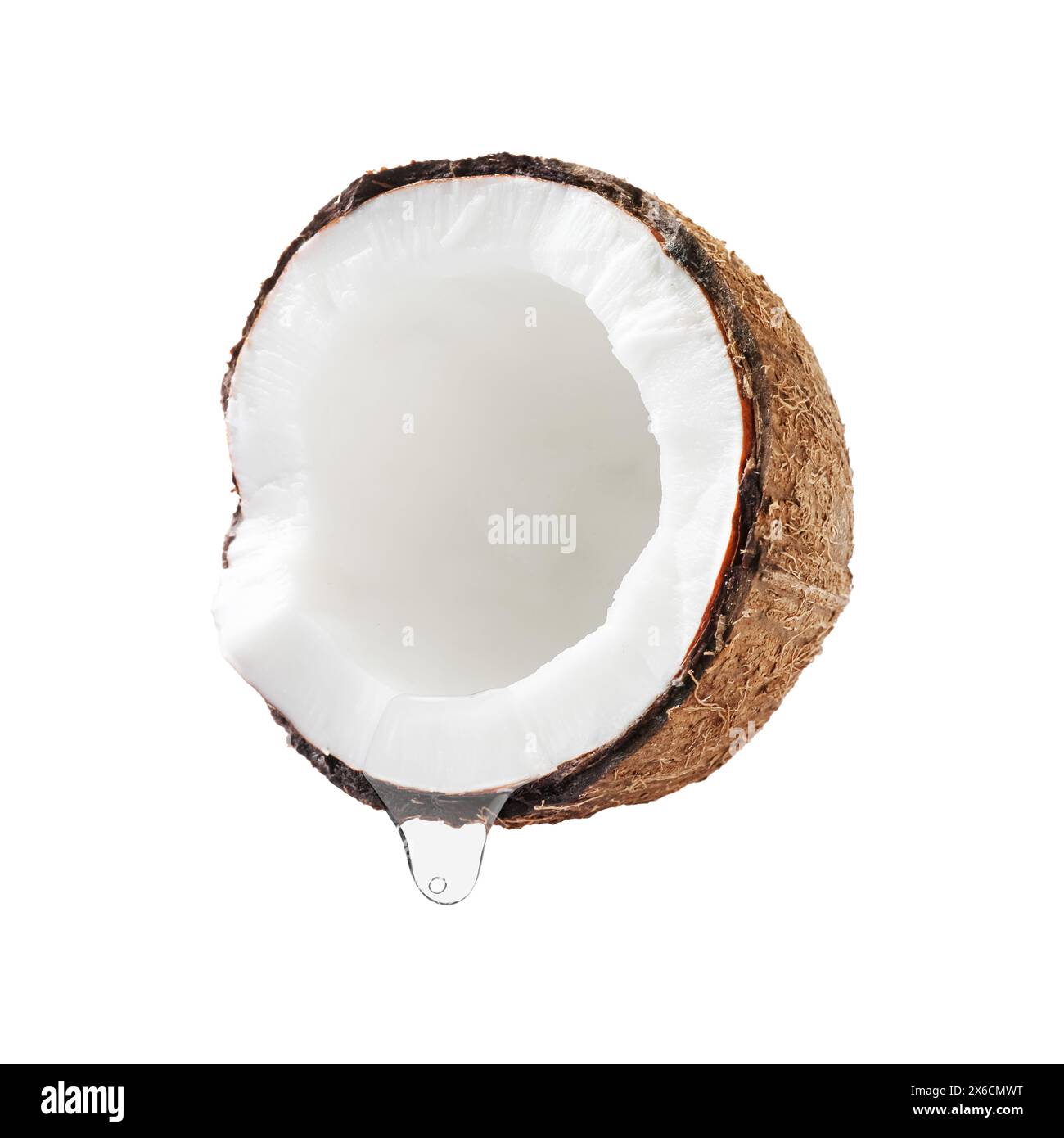 Kokosnuss mit tropfendem Öl isoliert auf weiß Stockfoto