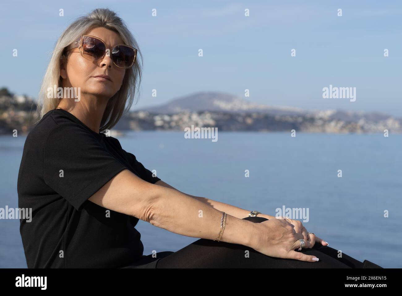 Dieses Bild zeigt ein atemberaubendes Porträt einer Frau in der idyllischen Umgebung von Calpe, Spanien. Stockfoto