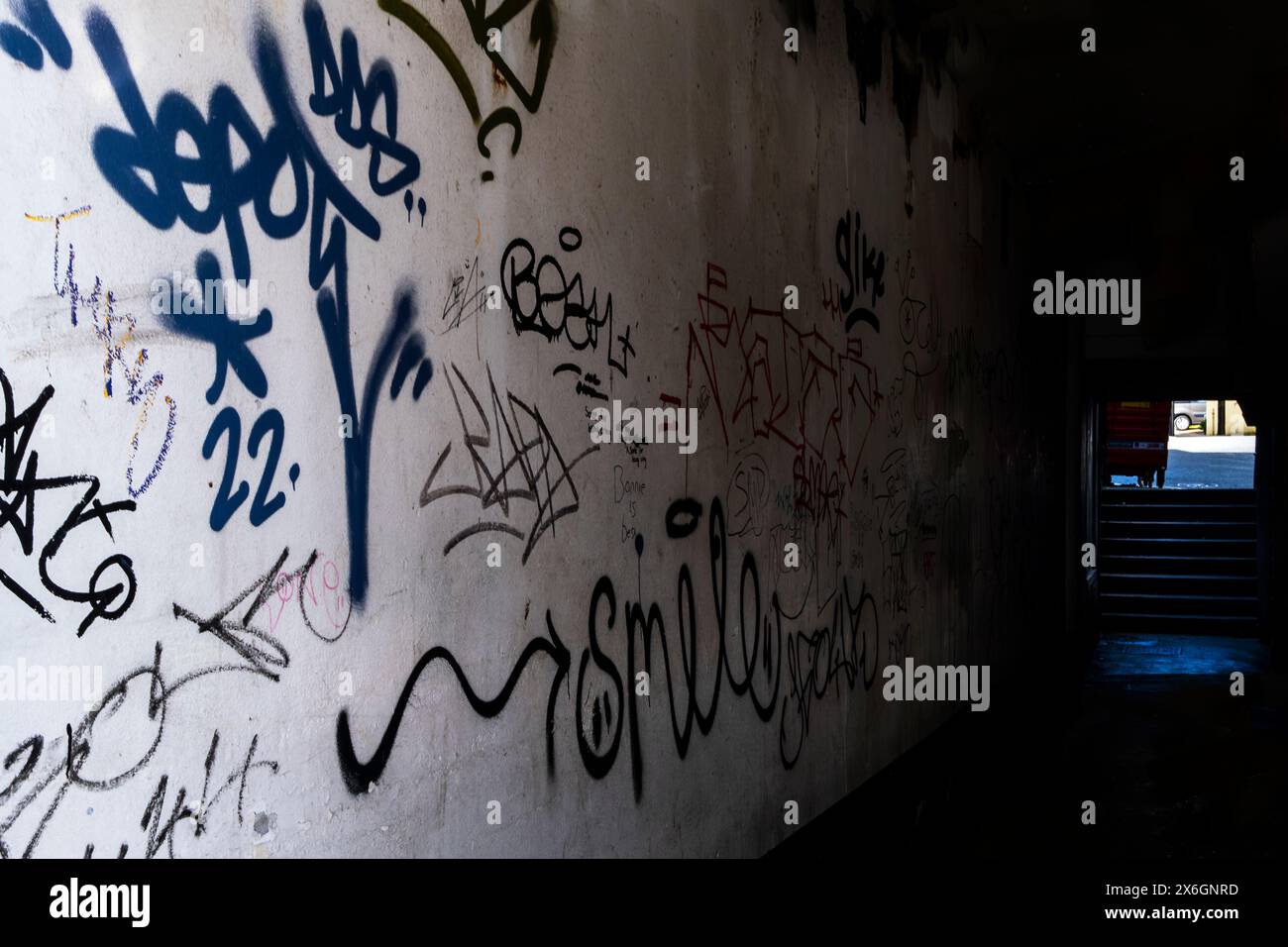 Hässliches Anti-Social-Tagging krabbelte an einer Wand in einem Seitengang im Stadtzentrum von Newquay in Cornwall in Großbritannien. Stockfoto