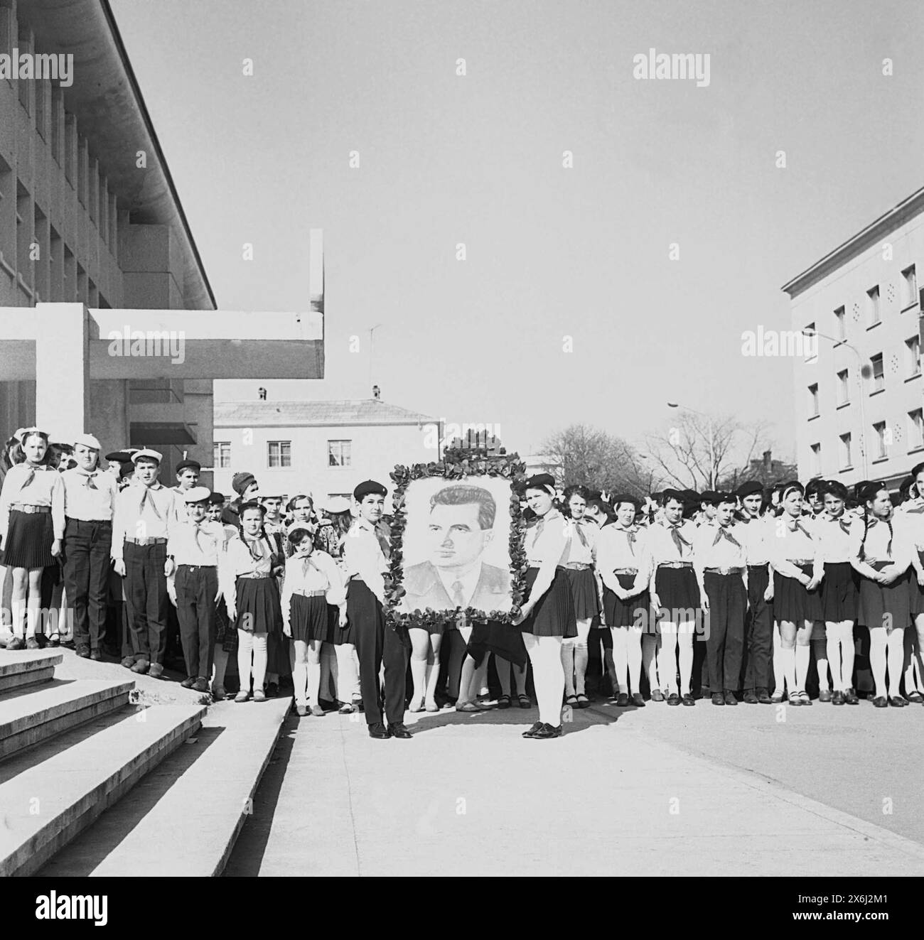 "Pioniere" - Schüler der Mittelschule in standardisierter Uniform im kommunistischen Rumänien in den 1970er Jahren mit einem Porträt des rumänischen kommunistischen Präsidenten Nicolae Ceausescu. Schulkinder wurden gewaltsam dazu gebracht, teilzunehmen, aufzutreten, Oden zu rezitieren und den Kommunismus, den Sozialismus und seine Führer zu loben. Stockfoto