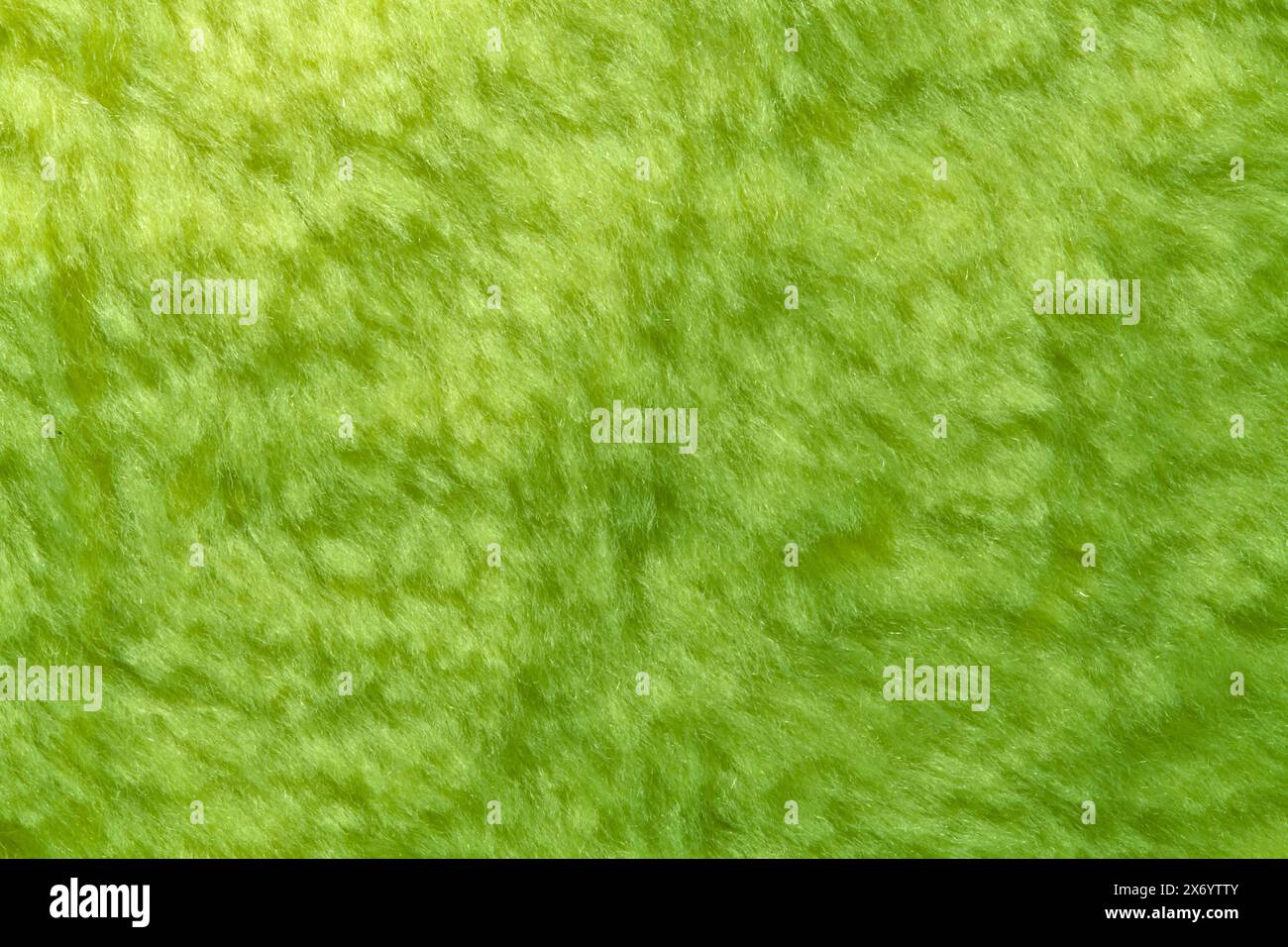 Die Textur des synthetischen haarigen grünen Materials Stockfoto