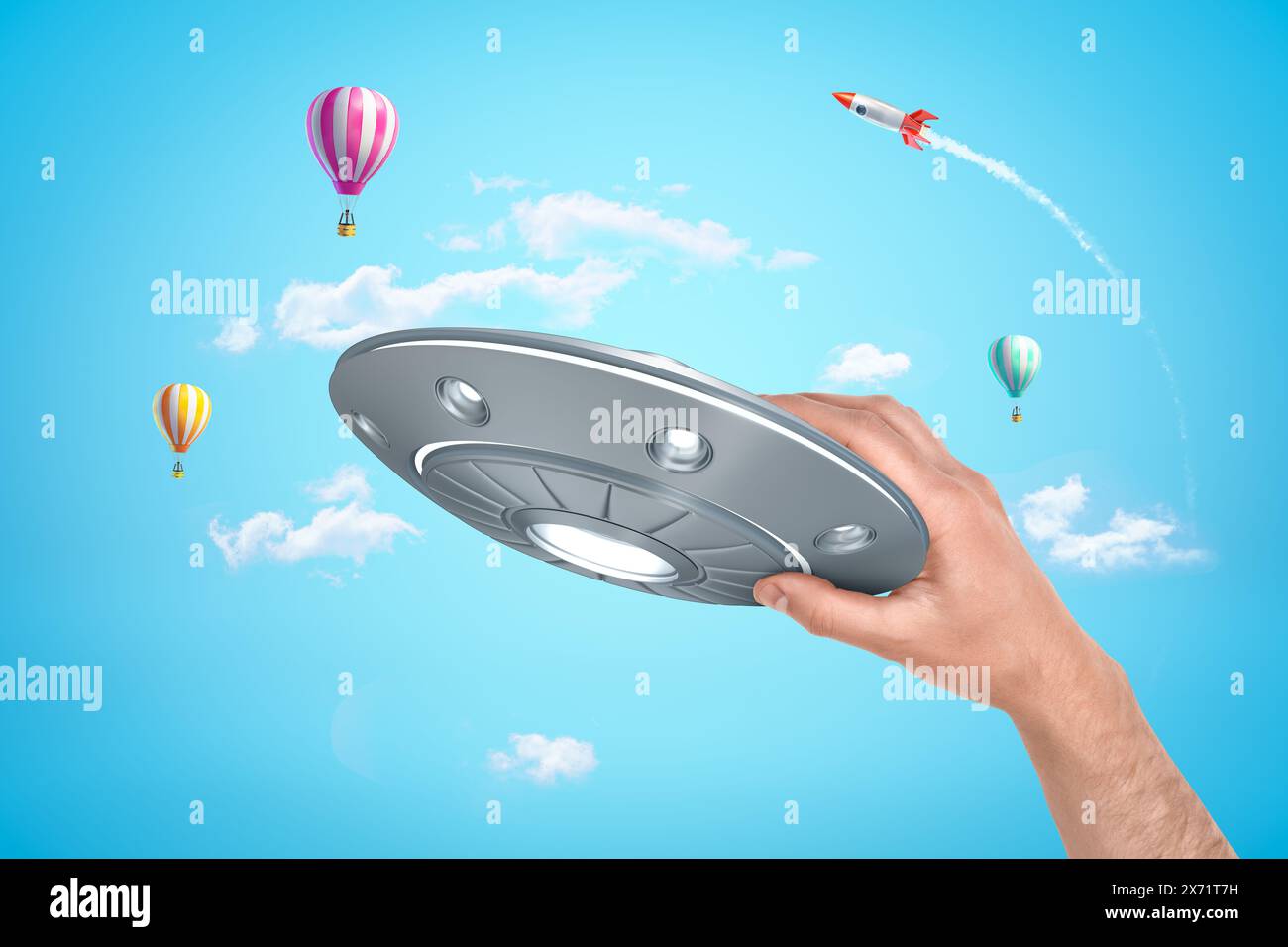 Hand hält UFO mit Luftballons und Rakete Stockfoto