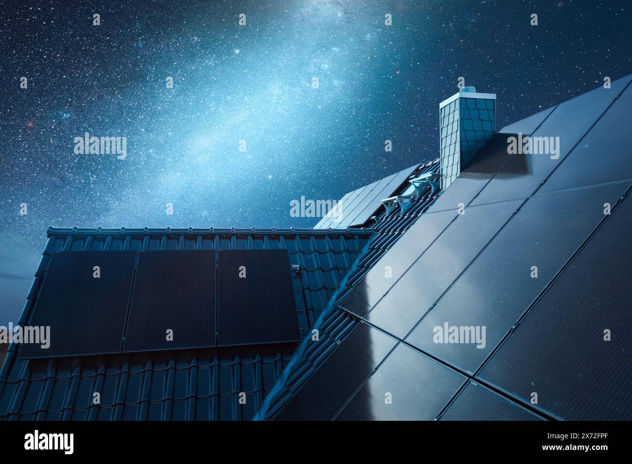 Dach eines Hauses mit Sonnenkollektoren unter einem Sternenhimmel Stockfoto