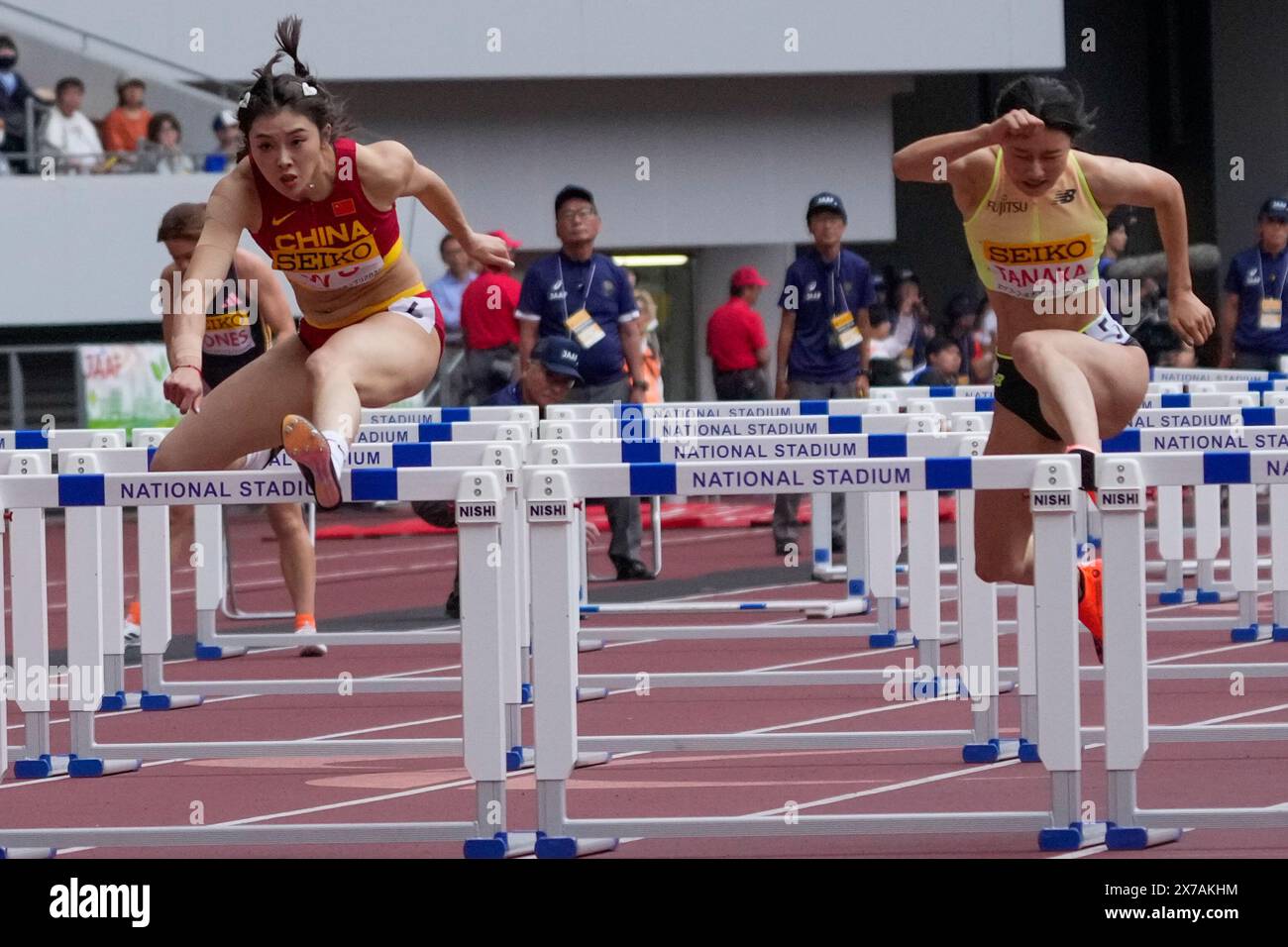Wu Yanni, left, of China leads Yumi Tanaka of Japan to win the women's