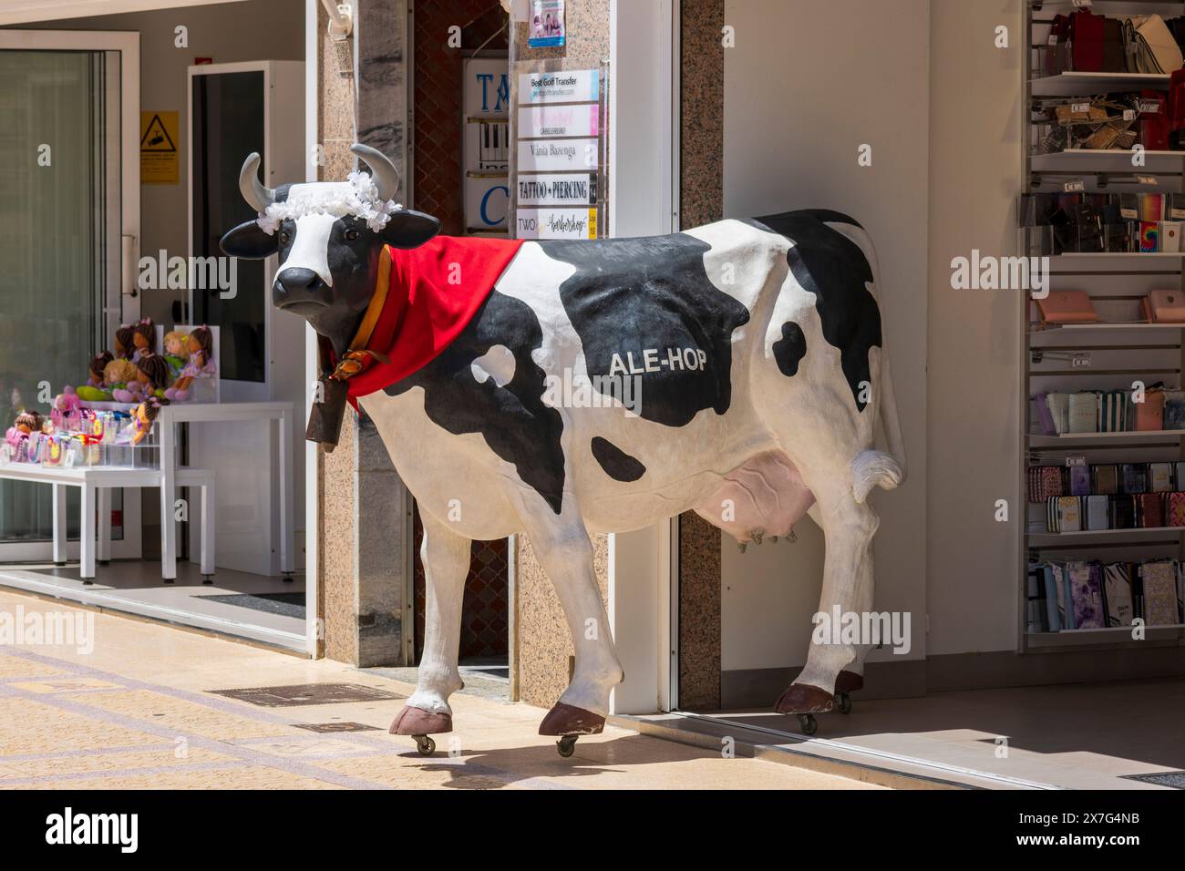 Kuh vor dem Ale-Hop Store in Vila Real de Santo Antonio, Eastern Algarve, Algarve, Portugal, Europa Stockfoto