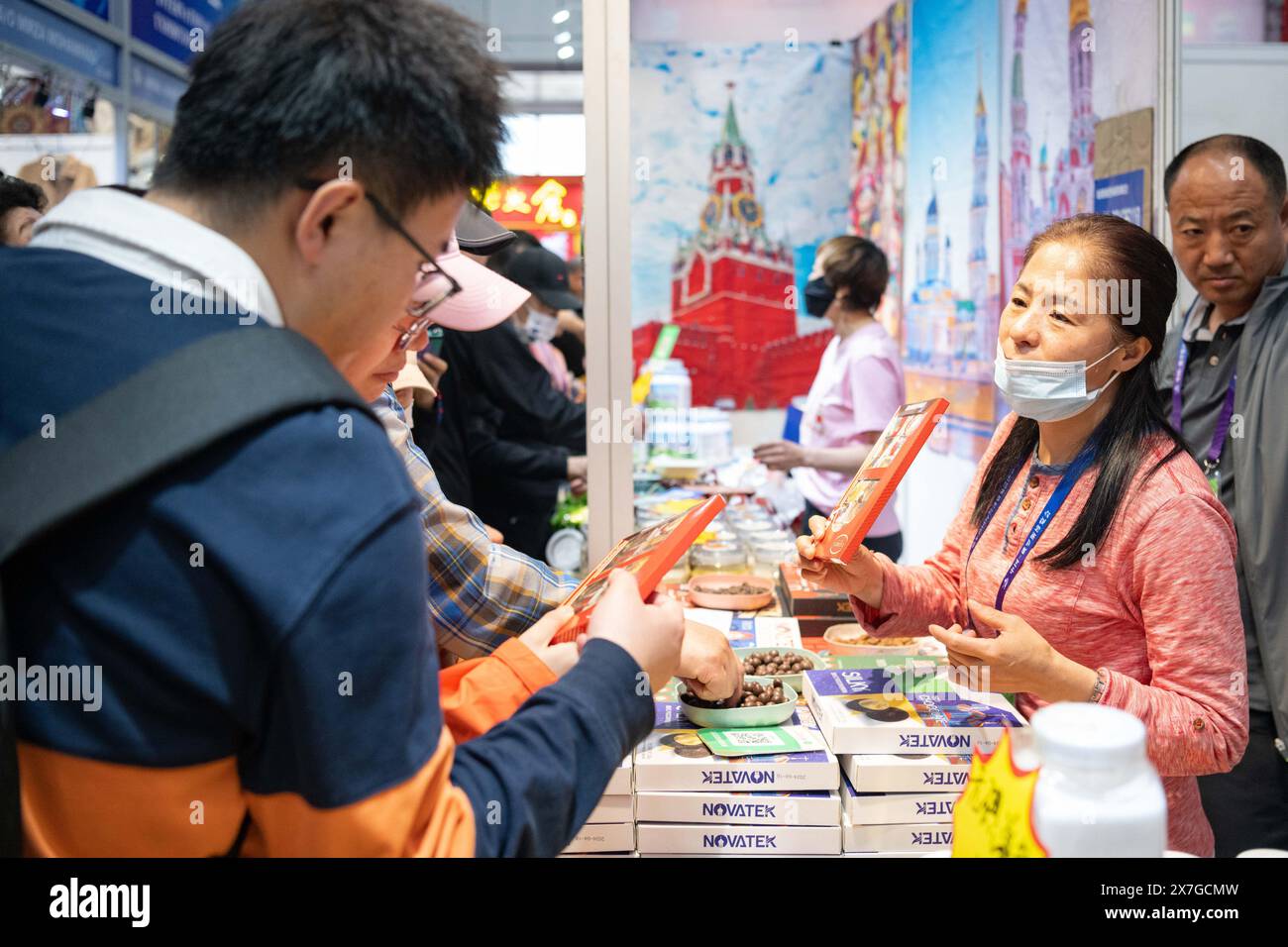 Harbin, Chinas Provinz Heilongjiang. Mai 2024. Besucher kaufen während der achten China-Russia Expo in Harbin, nordöstliche Provinz Heilongjiang, am 20. Mai 2024 ein. Über 5.000 ausländische Käufer registrierten sich auf der expo und Vertreter aus 44 Ländern und Regionen nahmen an der expo Teil. Die Ausstellungsfläche erstreckt sich auf 388.000 Quadratmetern und zeigt mehr als 5.000 Produkte in über 20 Hauptkategorien aus 10 Branchen. Die expo findet vom 16. Bis 21. Mai statt und ist auch ein kulinarisches fest, bei dem Besucher eine große Auswahl an Speisen und Getränken probieren können. Quelle: Xie Jianfei/Xinhua/Alamy Live News Stockfoto
