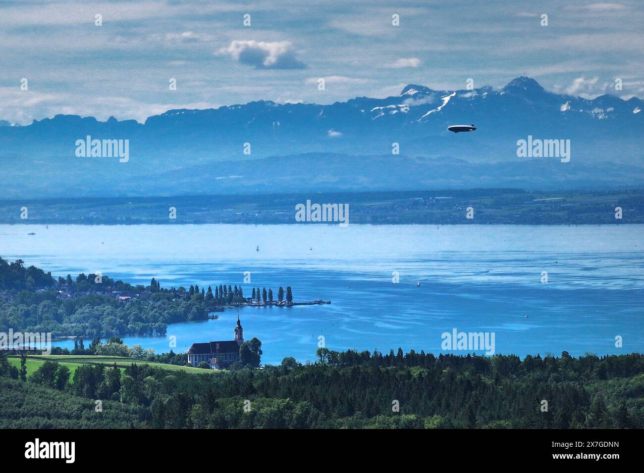 20. Mai 2024, Baden-Württemberg, Überlingen am Bodensee: Der zeppelin fliegt über den Bodensee in Richtung Friedrichshafen, während im Vordergrund die Barockkirche Birnau zu sehen ist. (Luftaufnahme mit Drohne) Foto: Felix Kästle/dpa Stockfoto