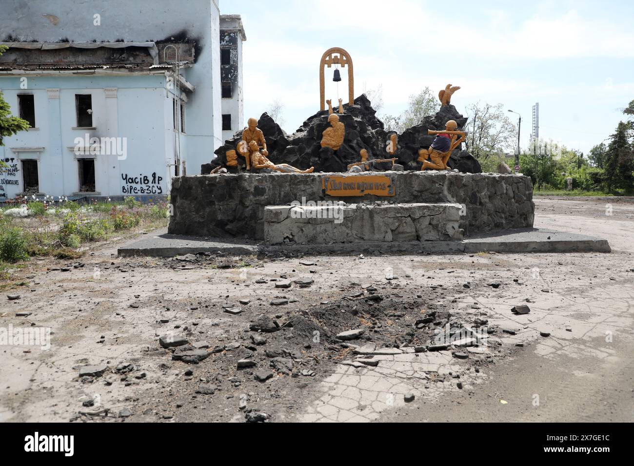 CHASIV YAR, UKRAINE - 18. MAI 2024 - das Denkmal für die Krieger des sowjetisch-afghanischen Krieges ist außerhalb des Kulturpalastes zu sehen, der am 23. Juli 2023 durch russische Bombenangriffe zerstört wurde, Chasiv Jar, Region Donezk, Ostukraine. Stockfoto