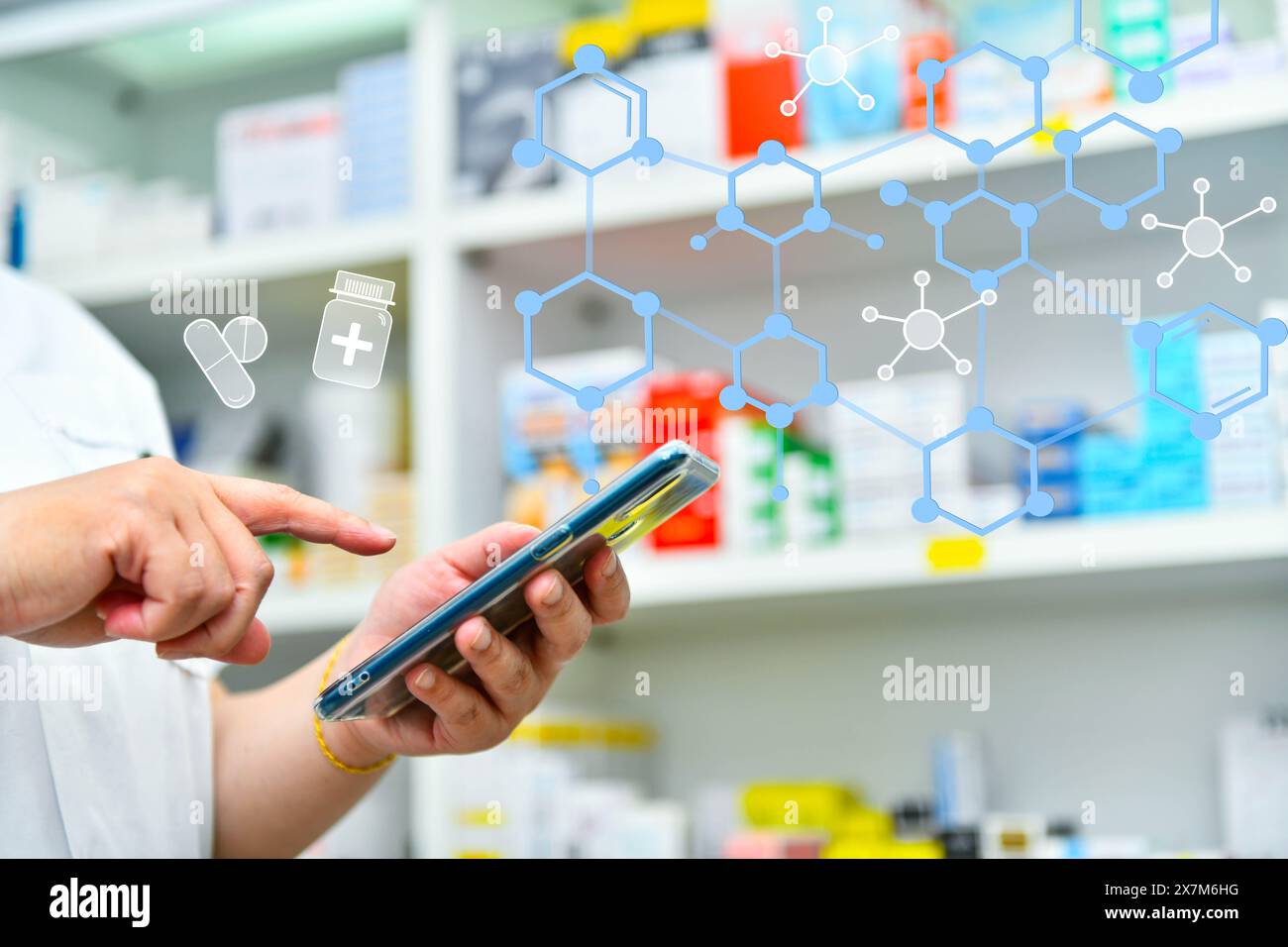 Ein Apotheker hält ein Mobiltelefon, um ein ärztliches Rezept zu erhalten, Medikamente zuzubereiten und Medikamente in einer Apotheke zu überprüfen. Stockfoto