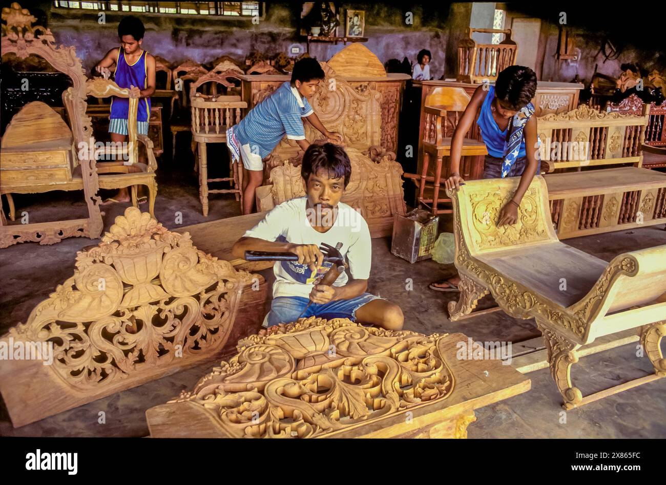 Philippinen, Luzon; Zimmermann schneidet Holz in einer Möbelfabrik. Stockfoto