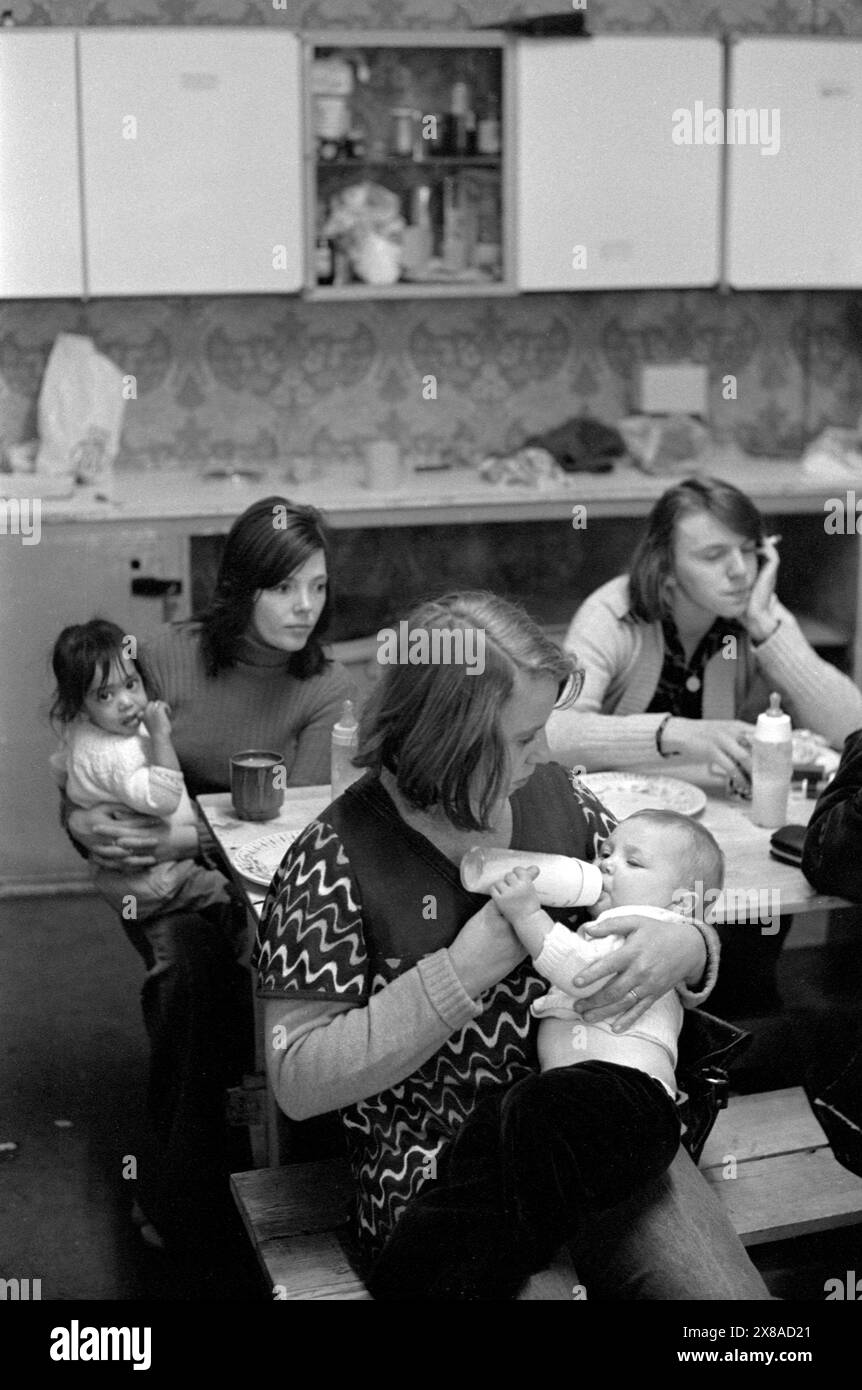 Chiswick Frauenhilfe. Jo Polaine, die Hausmutter, füttert ein Baby für eine der Mütter. Richmond, London, England, ca. November 1975. HOMER SYKES AUS DEN 1970ER JAHREN. Stockfoto