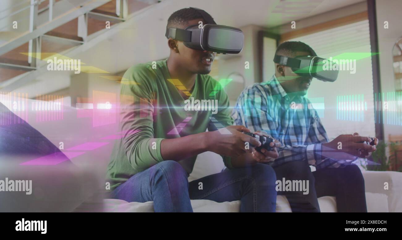 Zwei afroamerikanische Männer spielen Videospiele mit VR-Headsets Stockfoto