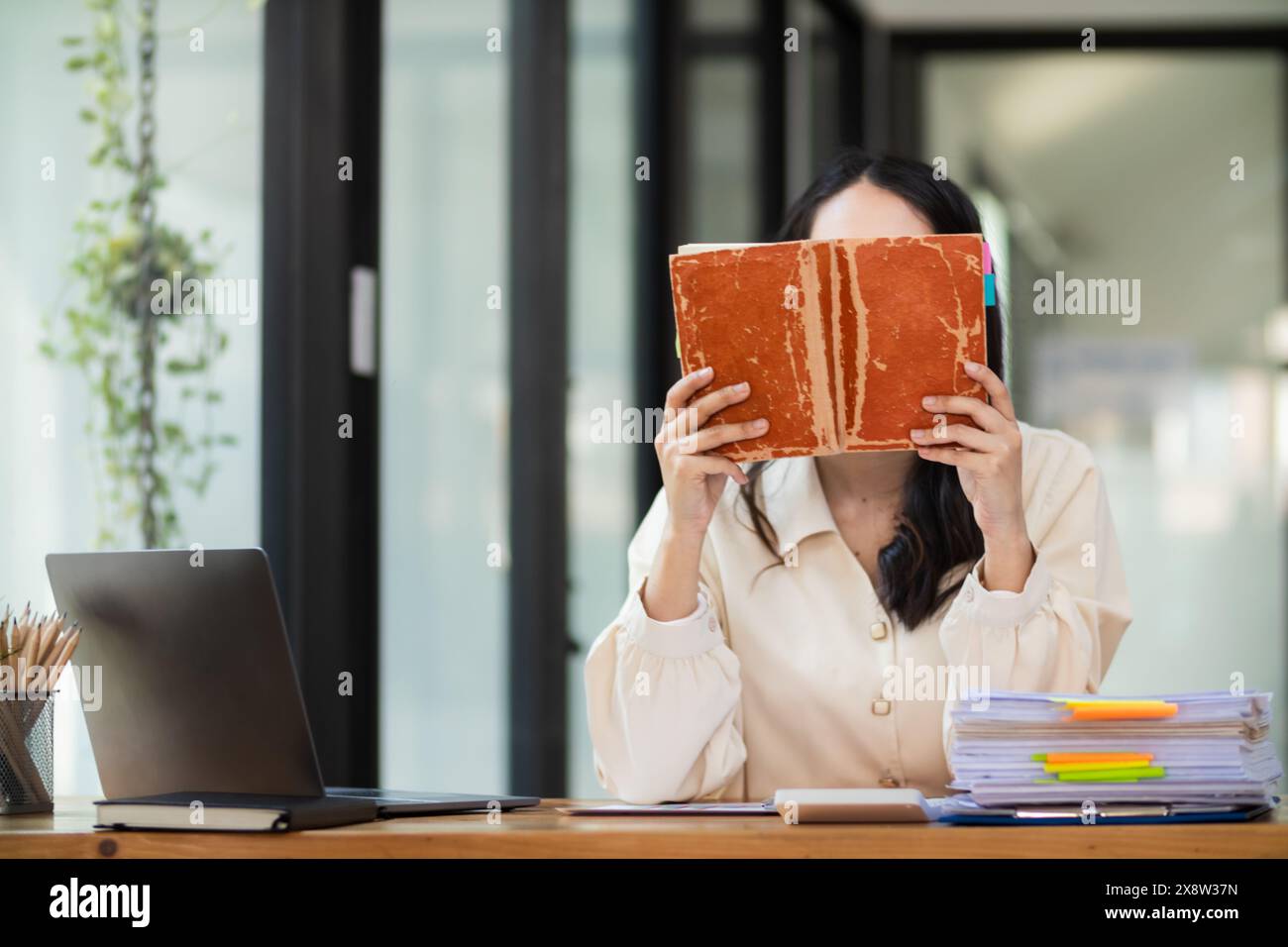 Die junge Frau hielt eine Bibel in der Hand und versuchte, Gottes Lehren aus der Bibel zu lernen und zu verstehen, die sie hielt. Glaubensbegriffe und die Macht von Stockfoto