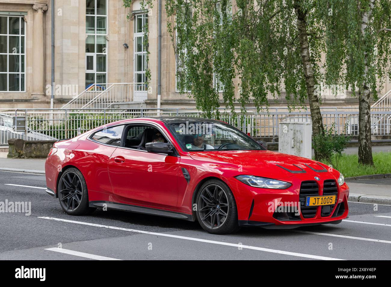 Luxemburg-Stadt, Luxemburg - Blick auf ein rotes BMW M4 Competition Coupé G82 auf einer Straße. Stockfoto