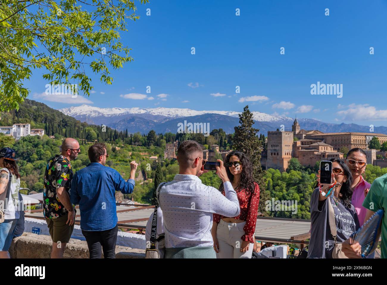 Granada, Spanien: 15. April 2024: Menschen in der Alhambra mit der Sierra Nevada im Hintergrund, Granada, Andalusien, Spanien Stockfoto