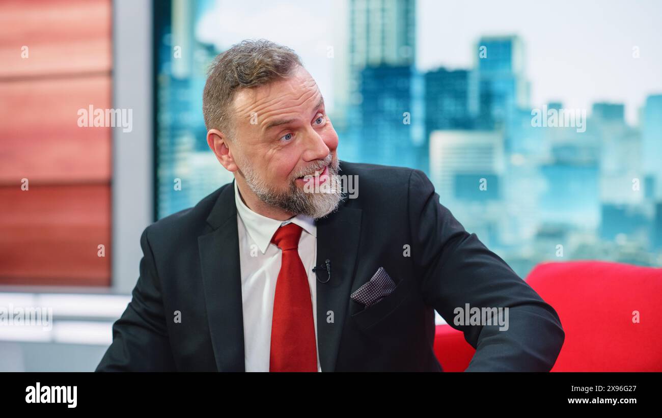 Talk Show TV-Programm, News Diskussion: Fröhlicher White Male Moderator spricht, hört Gäste zu. Host oder Gast des Kabelkanals haben Unterhaltung. Mockup TV Studio and Entertainment Concept Stockfoto