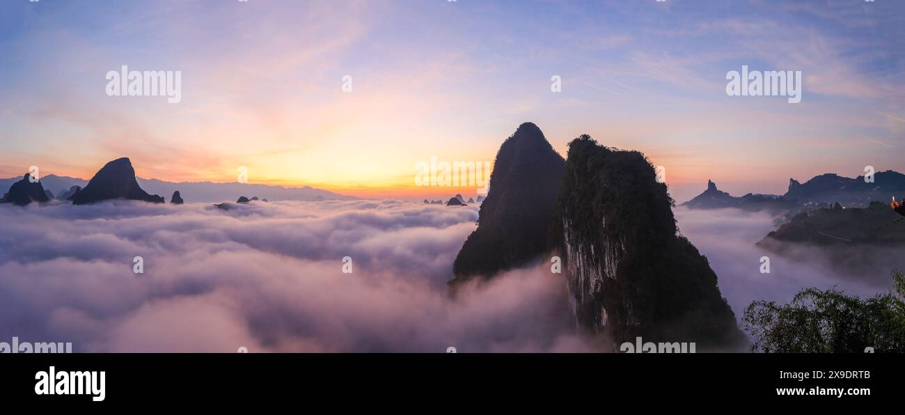 Sonnenaufgang über der natürlichen Landschaft des Karstbergs vom Xianggong Berg, mit rollenden Wolken rund um Guilin, Guangxi, China. Stockfoto
