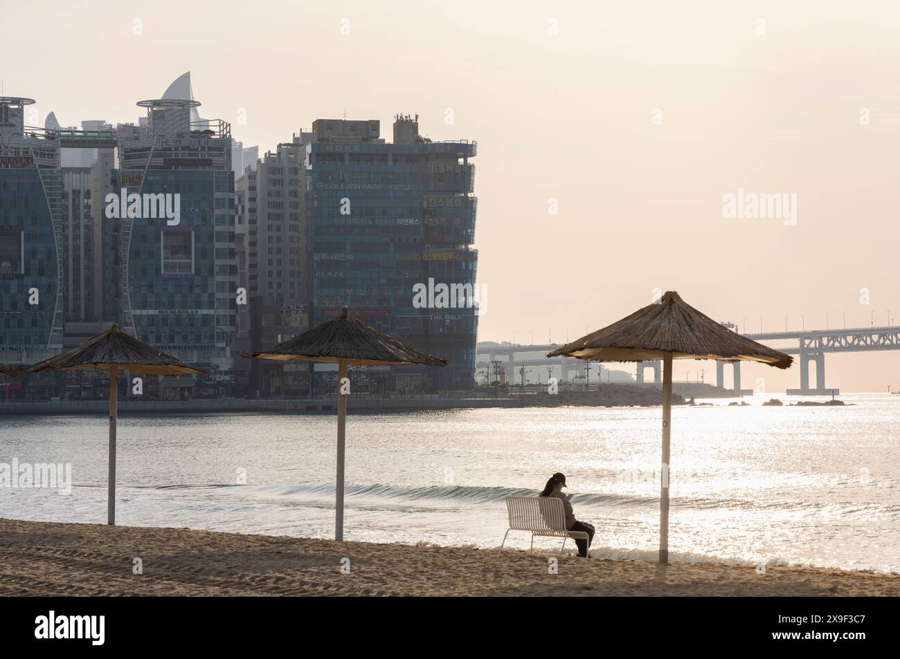 Frau sitzt am Gwangalli Beach, Busan, Südkorea Stockfoto