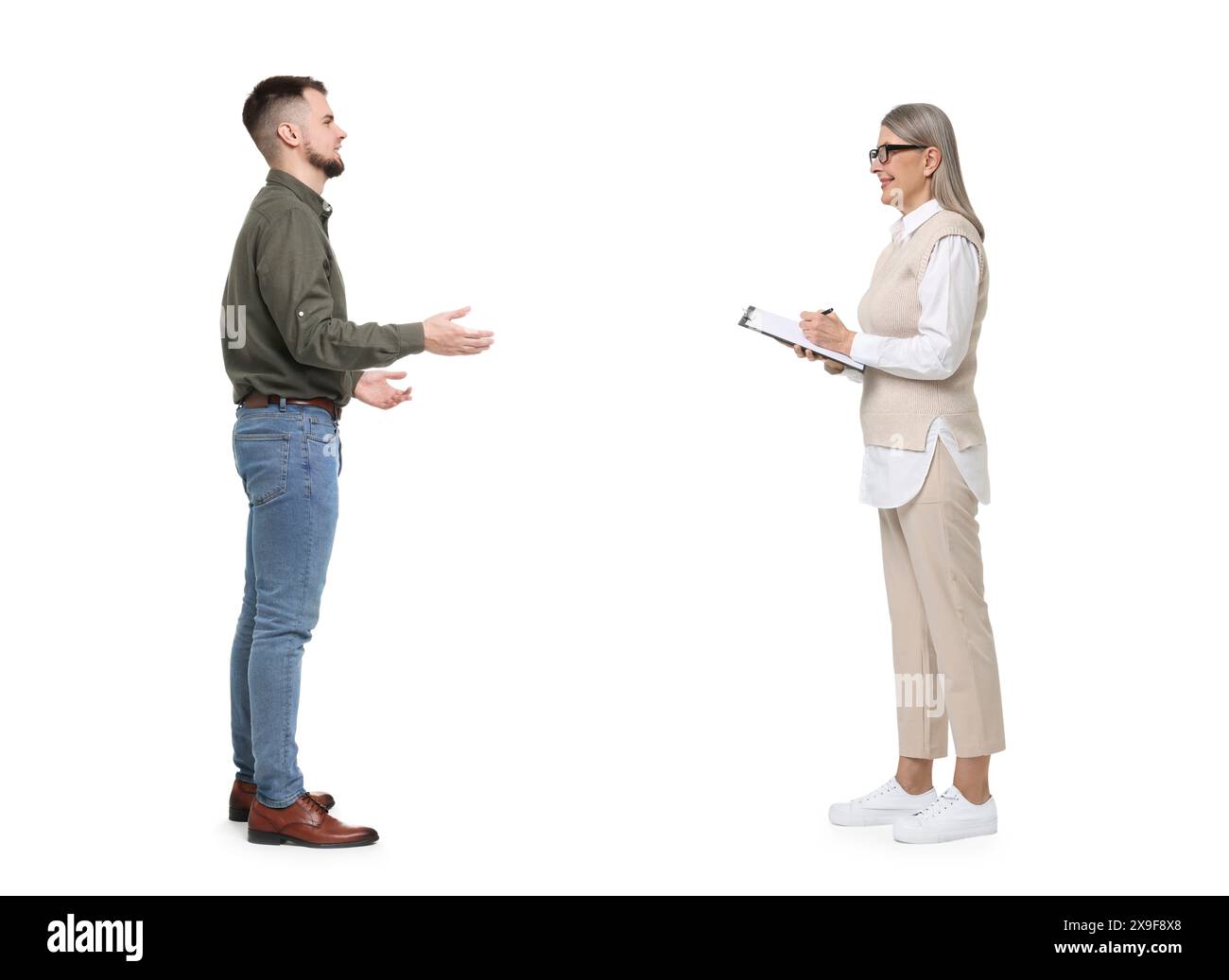 Junger Mann und ältere Frau, die auf weißem Hintergrund sprechen. Dialog Stockfoto