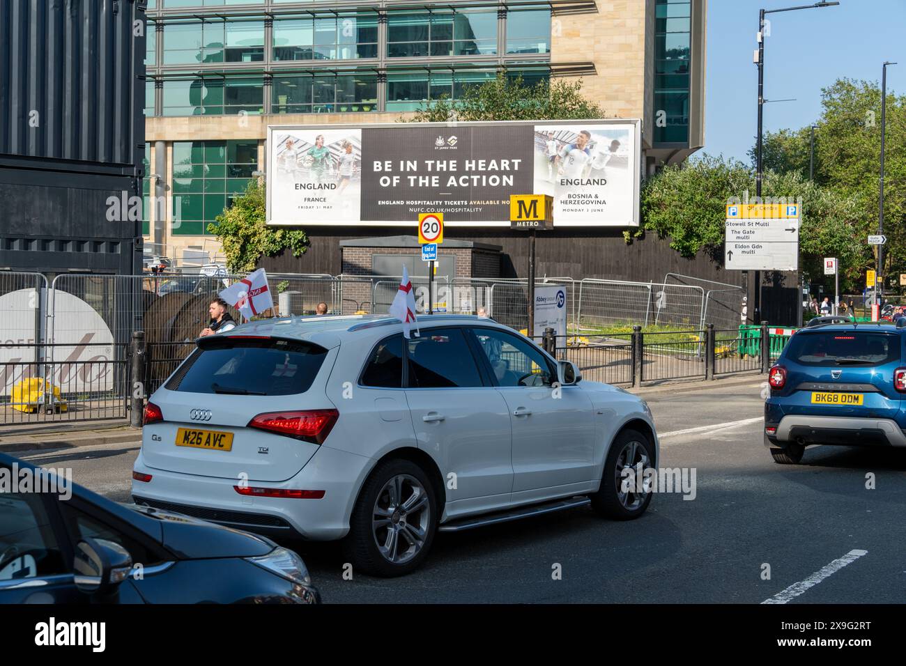 Newcastle upon Tyne, Großbritannien. Mai 31 2024. Fans in der Stadt, vor der Fußball-Qualifikation der England Women Euro 2025 gegen France Women, die im St. James' Park ausgetragen wird. - Ein Auto mit England-Flaggen fährt an einer Plakatwand vorbei. Quelle: Hazel Plater/Alamy Live News Stockfoto
