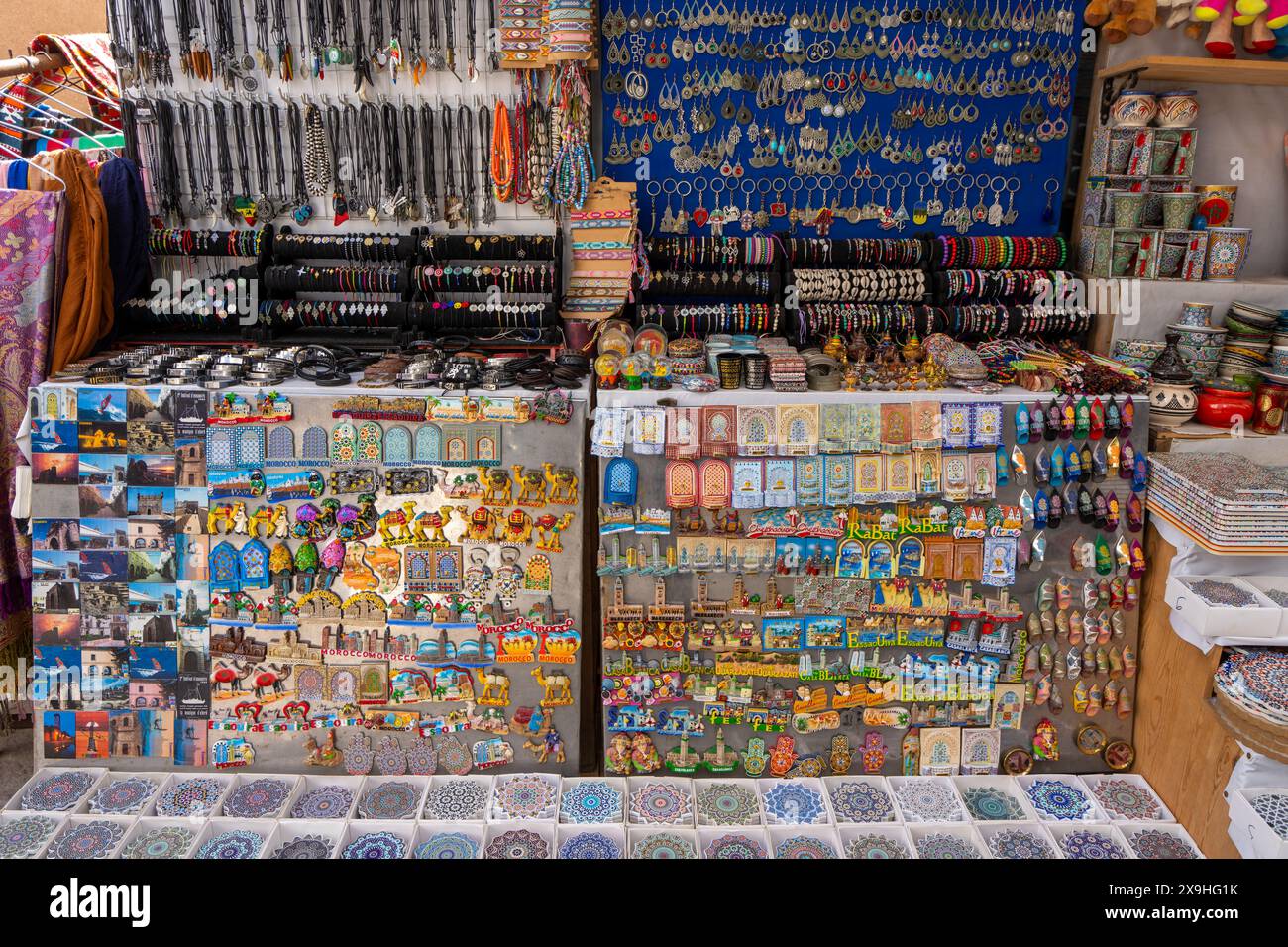 Essaouira, Marokko - 17. März 2024: An den Marktständen werden lebhafte Ausstellungen marokkanischer Handwerkskunst wie Postkarten, Schmuck und Fliesen gezeigt. Stockfoto