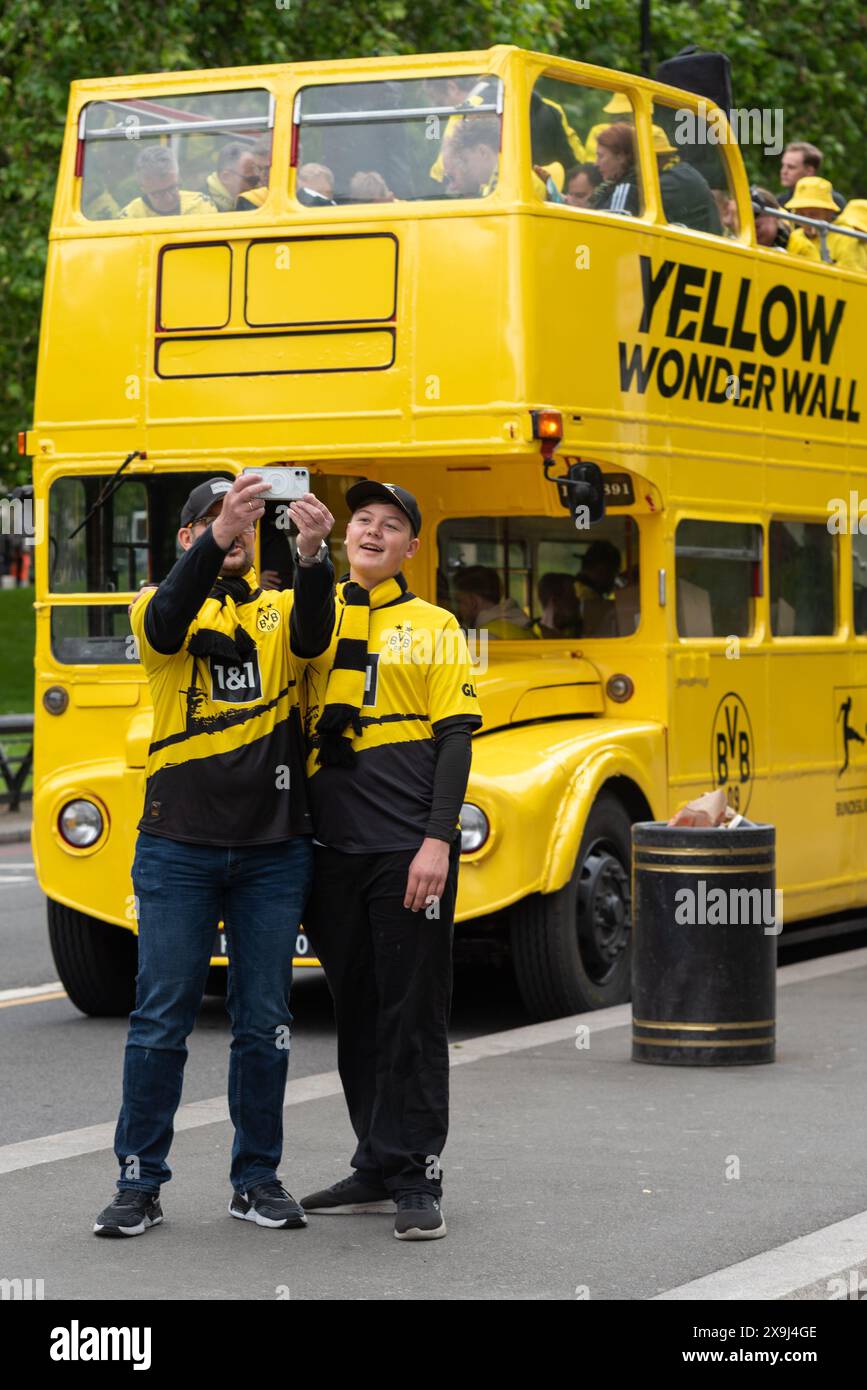 Park Lane, London, Großbritannien. Juni 2024. Im Wembley Stadium findet am Abend das UEFA Champions League-Finale zwischen Borussia Dortmund und Real Madrid statt. Hyde Park ist ein Treffpunkt für Fans der Teams. Offener Routemaster-Bus mit gelber Wunderwand und BVB-Grafiken Stockfoto