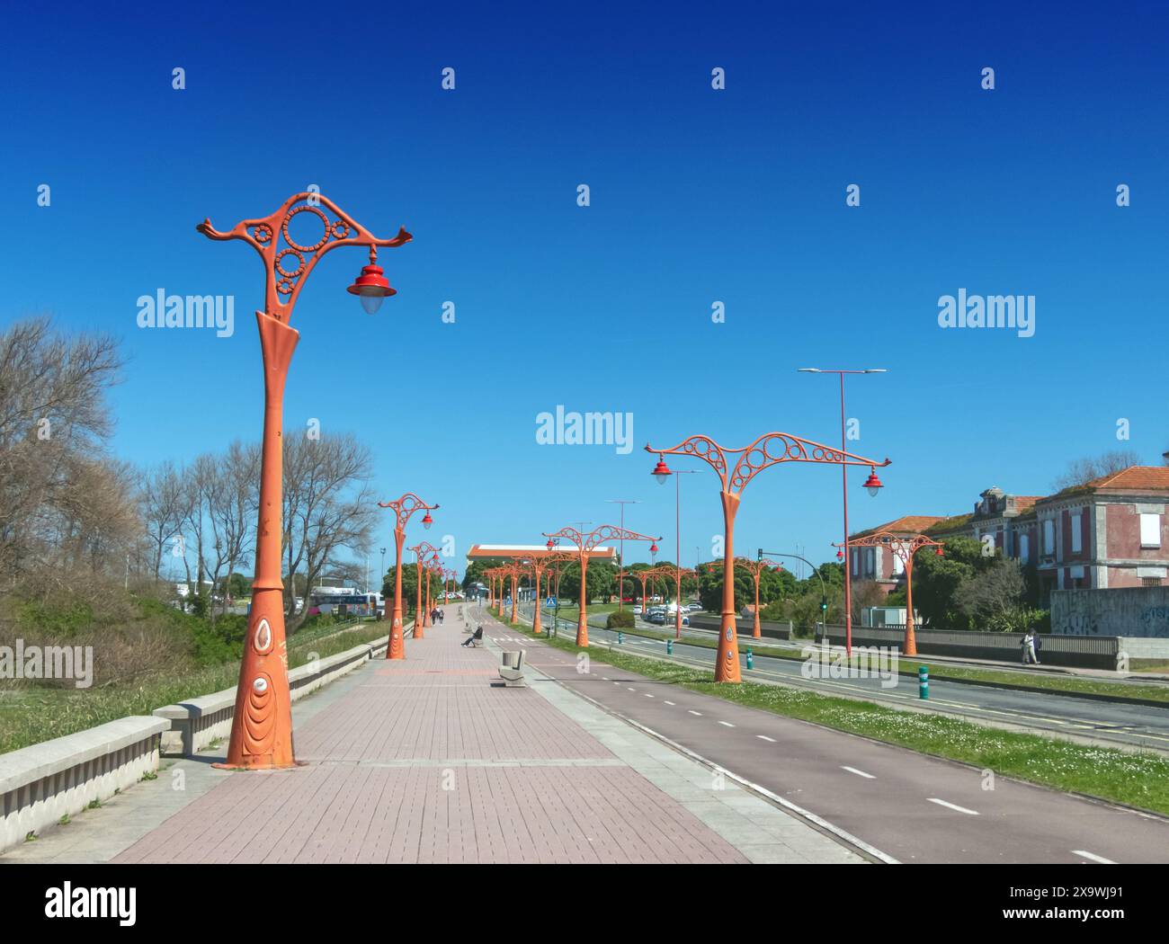 LA CORUNA, SPANIEN - 22. APRIL 2024: Rote Straßenlaternen an der Uferpromenade in La Coruna, Galicien, Spanien. Architekt Antonio Desmonts. Stockfoto