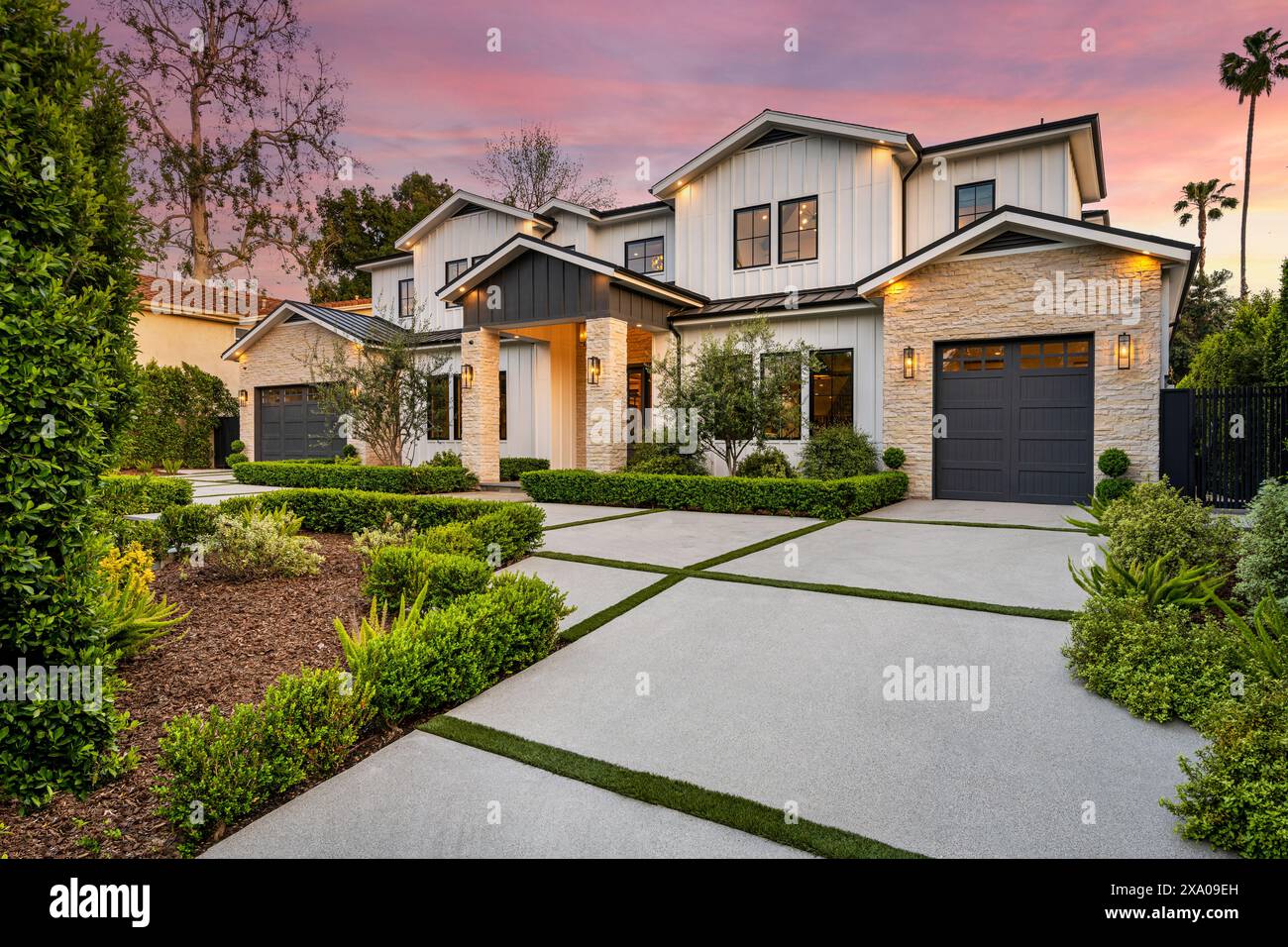 Ein Haus in einem charmanten Viertel mit atemberaubender Gartenanlage auf dem Bürgersteig. Stockfoto