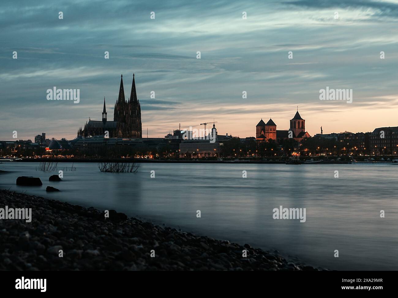 Ein Blick auf den Kölner Dom auf der linken Seite und die St. Kunibert Kirche, in der Mitte fließt der Rhein Stockfoto