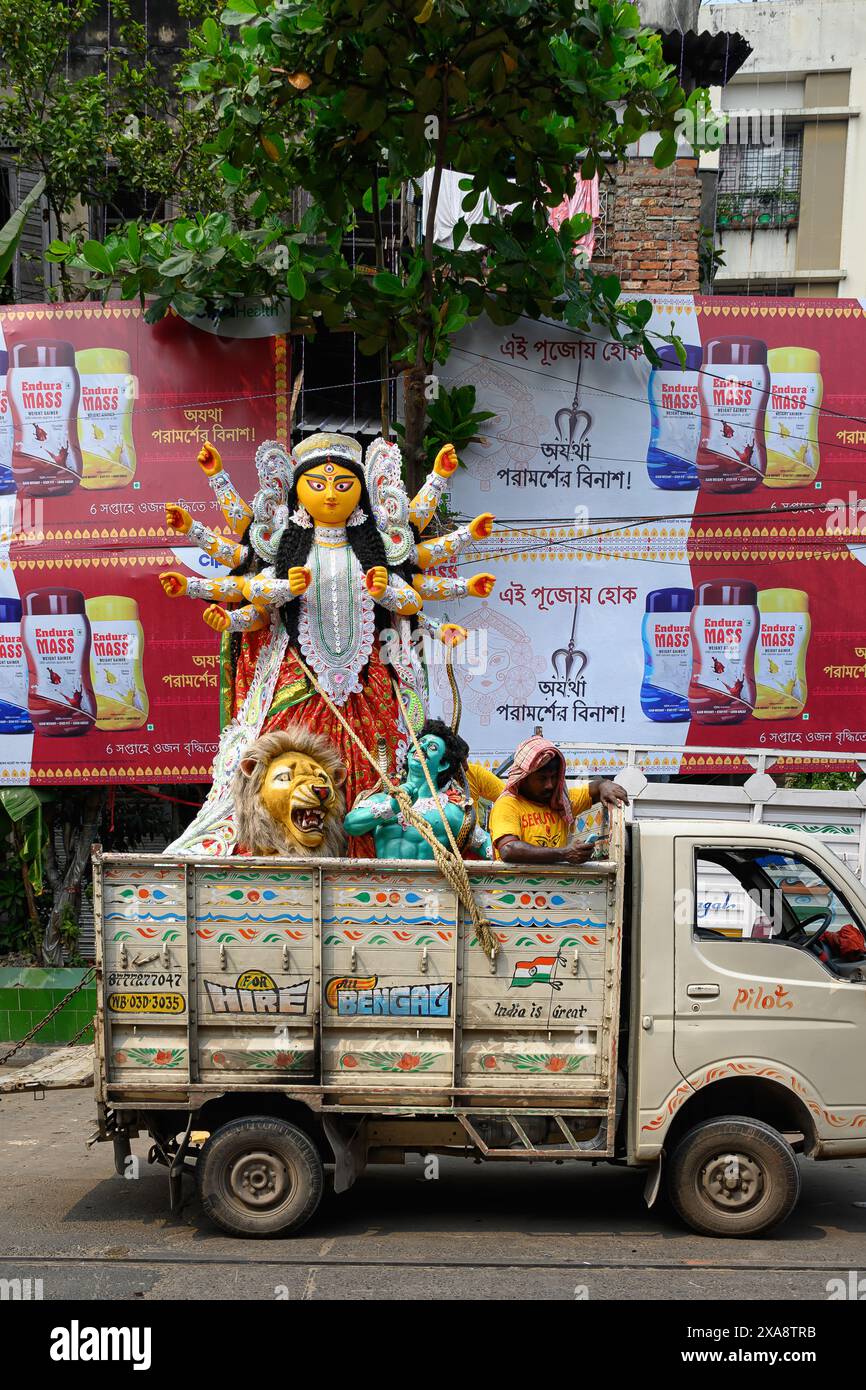 Das Idol der Göttin Devi Durga wird für das bevorstehende Durga Puja Festival in einem Töpferstudio in Kolkata, Westbengalen, Indien auf den Kleinwagen geladen Stockfoto