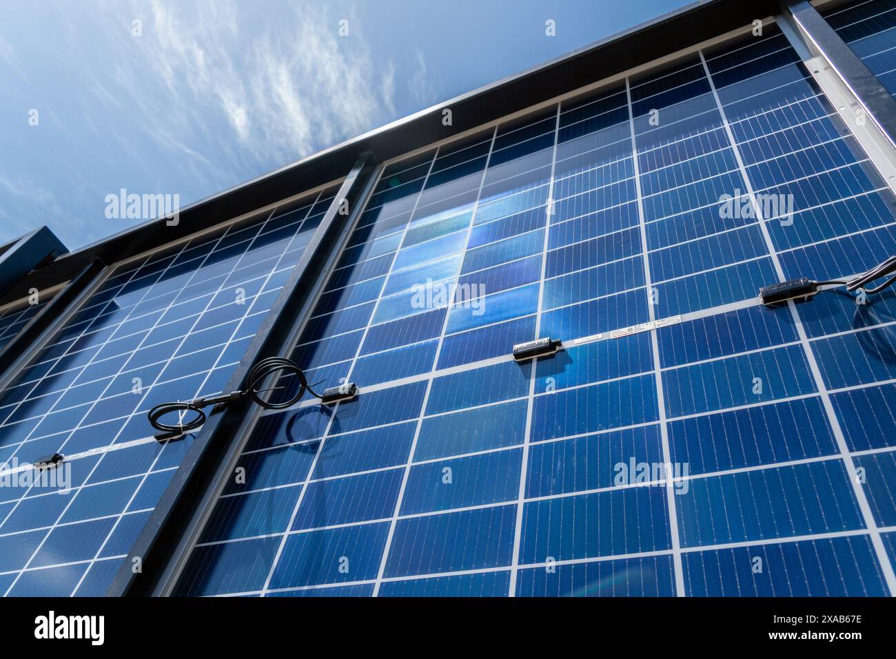 Rückseite der Solarpaneele im Solarkraftwerk vor blauem Himmel. Herstellung und Installation von Solarpaneelen. Stockfoto